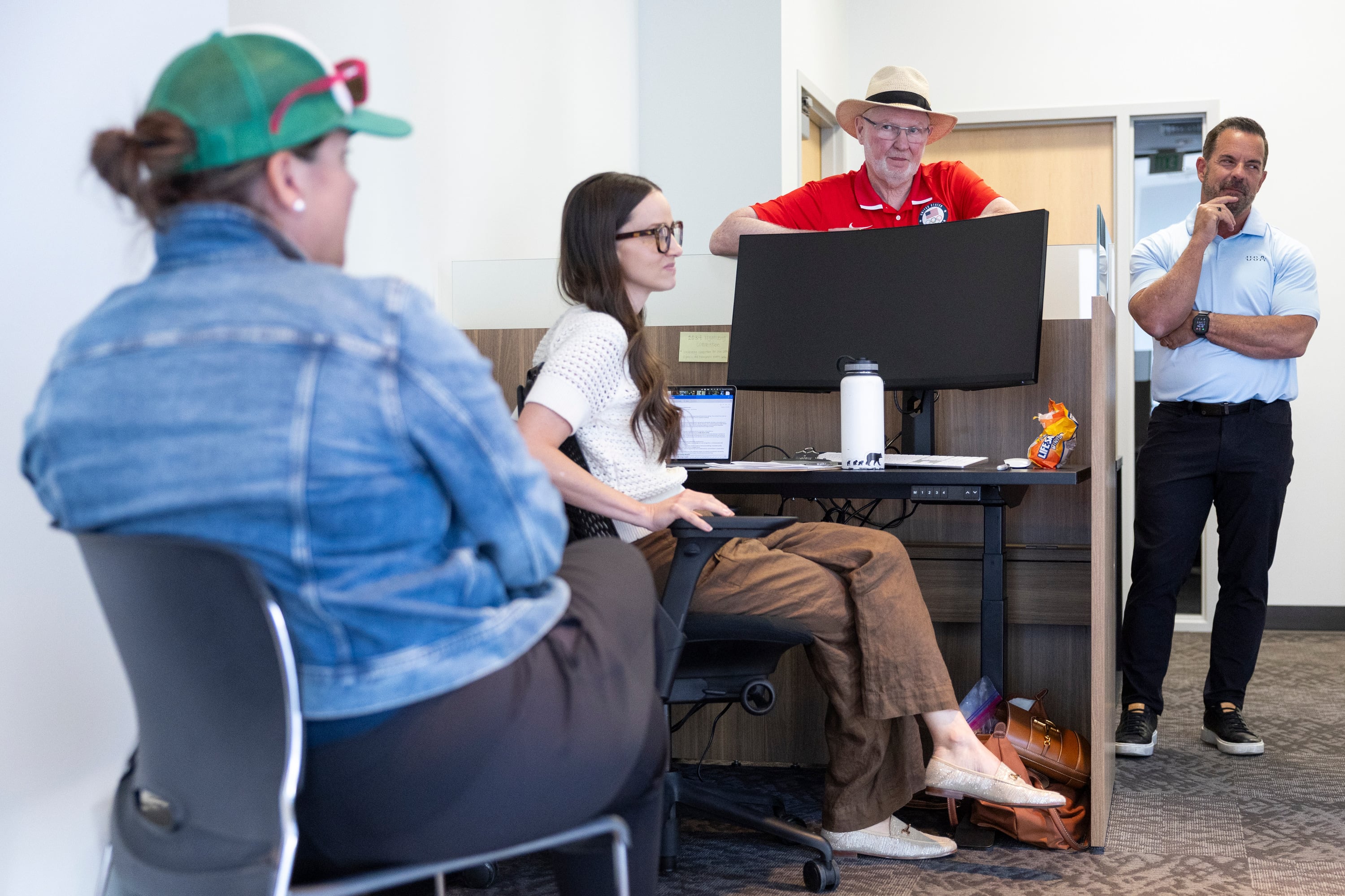 Catherine Raney-Norman, Rachel Alder, Tom Kelly and Brad Wilson during a tour of the Organizing Committee for the Olympic Games offices in Salt Lake City on Thursday. The recently donated offices will become the committee's home base.