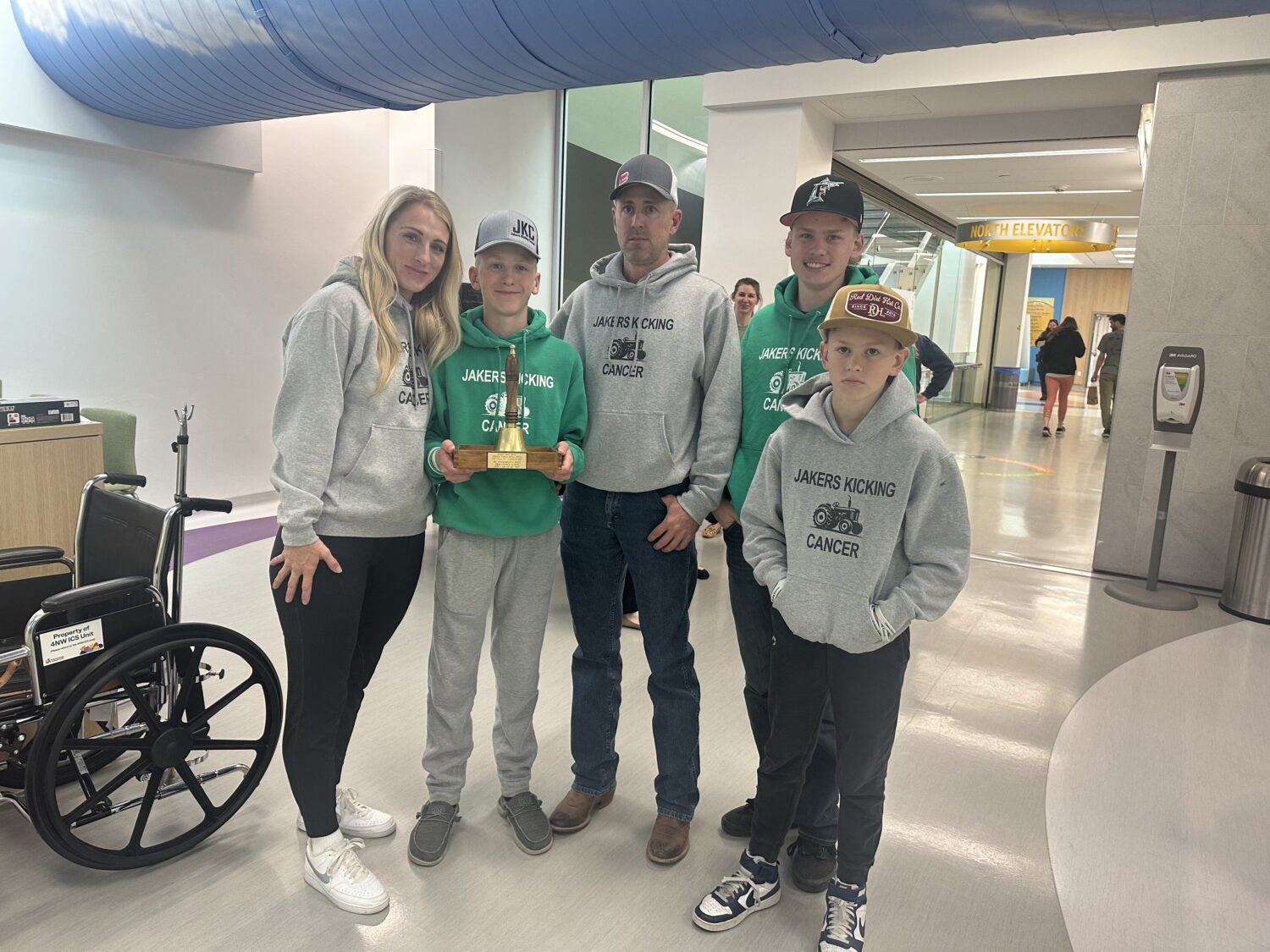 Jake Williams with his family, ringing the bell to celebrate the end of cancer treatments. He drove a wagon team of horses as the Days of '47 Rodeo kicked off Tuesday.