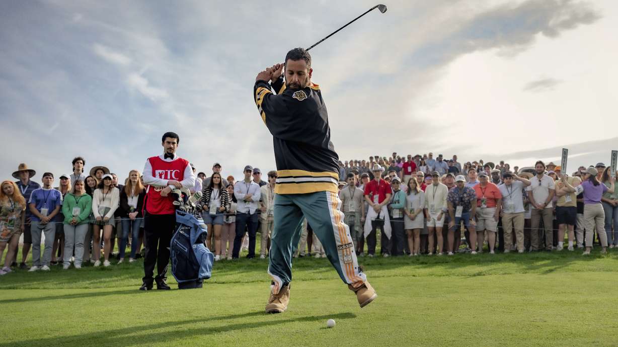 This image released by Netflix shows Benito Antonio Martínez Ocasio, left, and Adam Sandler in a scene from "Happy Gilmore 2."