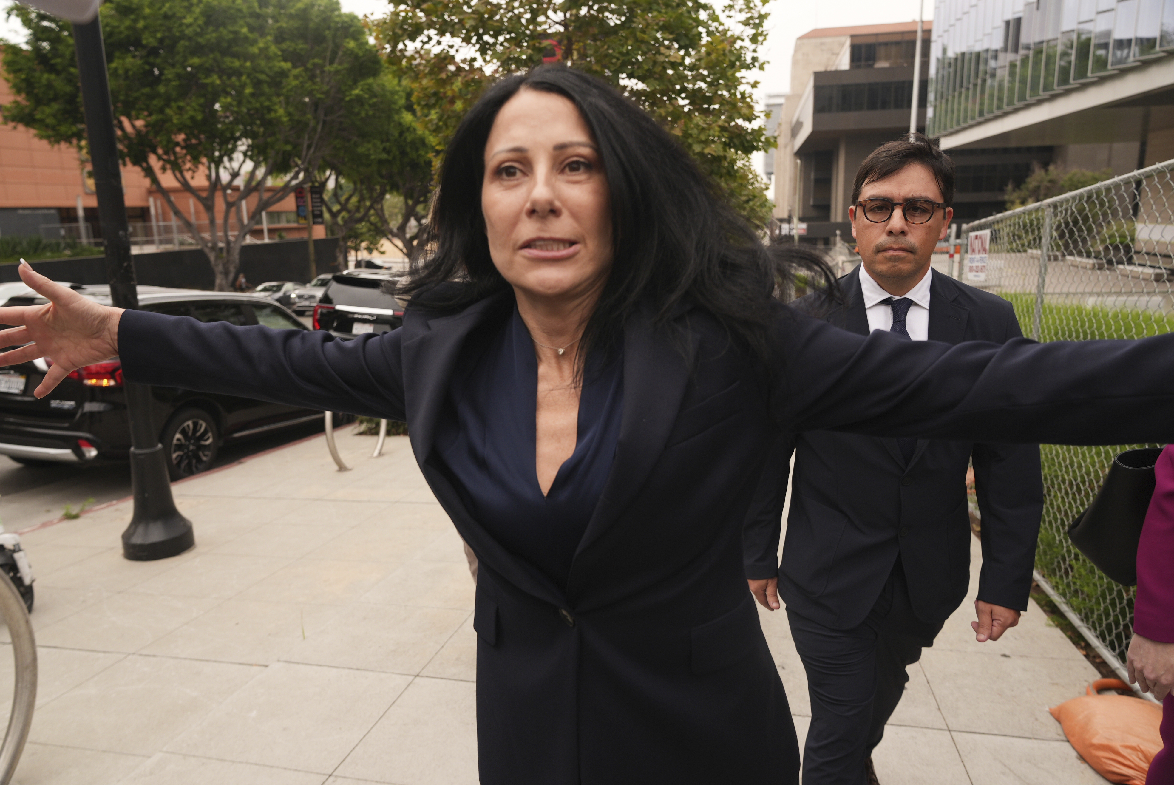 Dr. Salvador Plasencia walks behind his attorney, Debra S. White, as he leaves federal court on Wednesday in Los Angeles. Plasencia left federal court without speaking to any reporters.