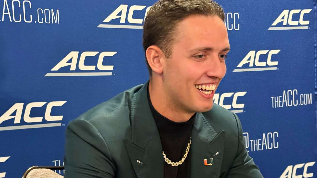 Miami quarterback Carson Beck, who transferred from Georgia, speaks at the Atlantic Coast Conference NCAA college football media days, Tuesday, July 22, 2025, in Charlotte, N.C.