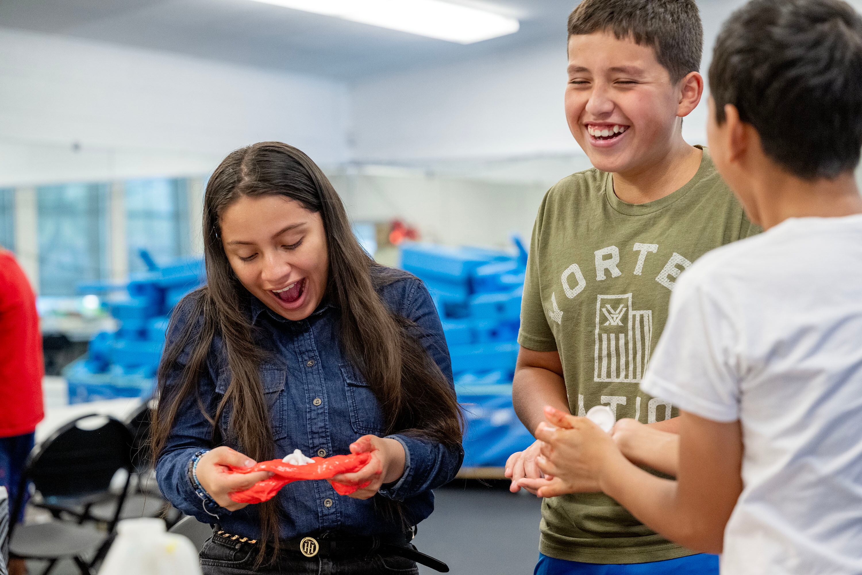 Diana, Felipe and Aman share a laugh as they make slime during summer activities at Central Park Community Center in South Salt Lake on July 14. Forty percent of public funding for programs like these come from federal grants, according to Ben Trentelman, executive director of the Utah Afterschool Network.