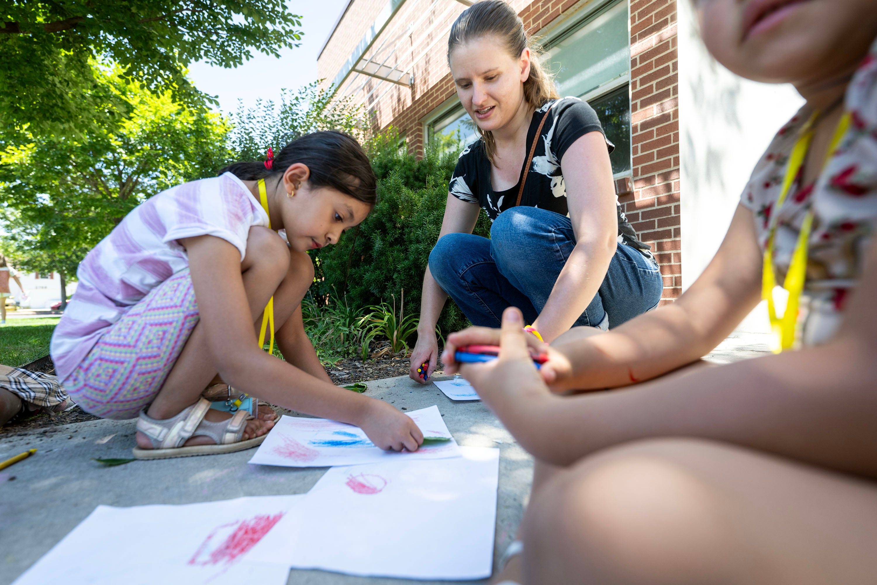 Aliza is assisted with her art by Girls Scouts troop leader Melissa King during summer activities at Central Park Community Center in South Salt Lake on July 14. Ten thousand Utah kids attend programs that are funded by the 21st Century Community Learning Center grant, according to Ben Trentelman, executive director of the Utah Afterschool Network.