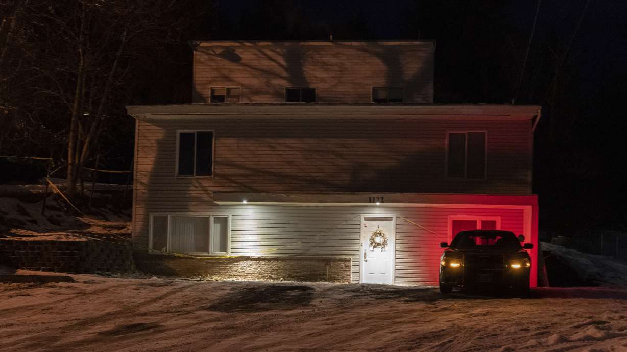 A private security officer sits in a vehicle, Jan. 3, 2023, in front of the house in Moscow, Idaho, where four University of Idaho students were killed in November 2022. Moscow police have released documents detailing their investigation into the murders.