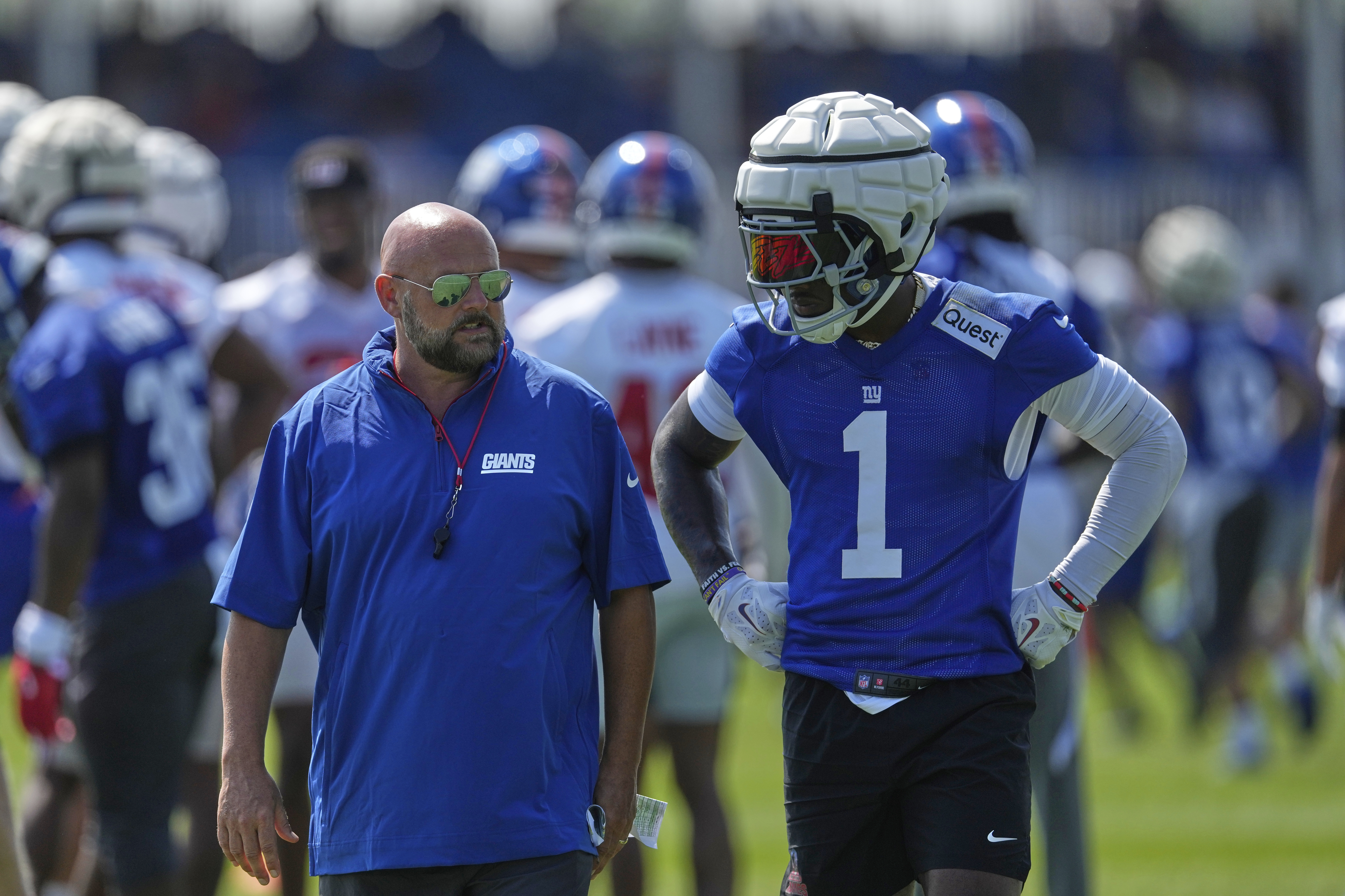 New York Giants wide receiver Malik Nabers, right, talks with head coach Brian Daboll during a practice at the team's NFL football training camp in East Rutherford, N.J., Thursday, July 24, 2025.