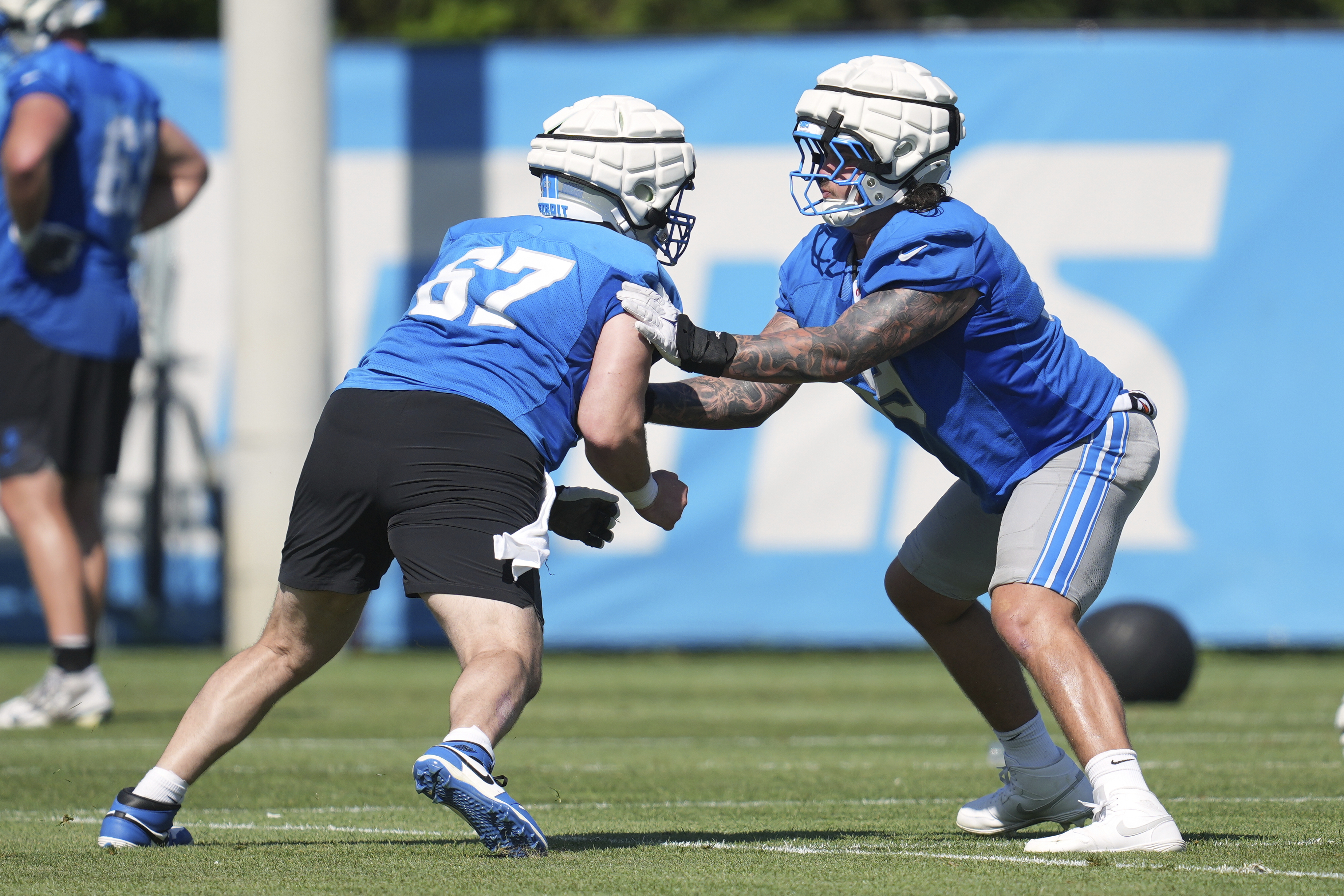 Detroit Lions offensive lineman Tate Ratledge, right, blocks Trystan Colon (67) after an NFL football practice in Allen Park, Mich., Tuesday, July 22, 2025. 