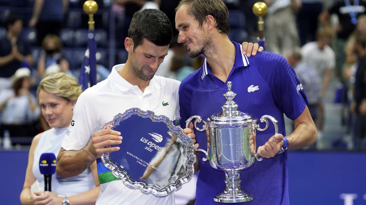 FILE- Daniil Medvedev, of Russia, right, talks with Novak Djokovic, of Serbia, after defeating Djokovic in the men's singles final of the US Open tennis championships, Sept. 12, 2021, in New York.