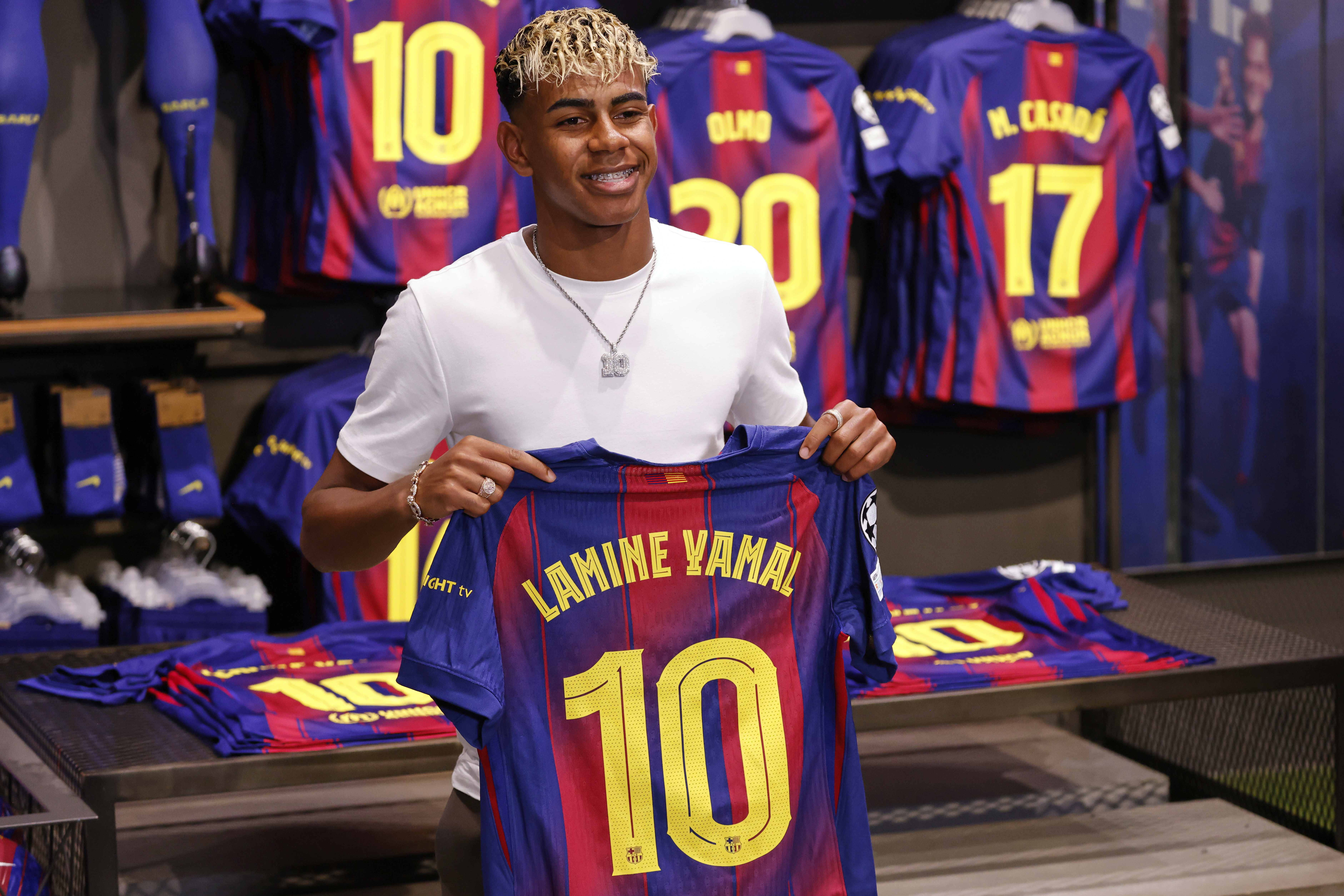 FC Barcelona player Lamine Yamal poses with his new jersey after signing a contract extension with the soccer club in Barcelona, northern Spain, Wednesday, July 16, 2025. 