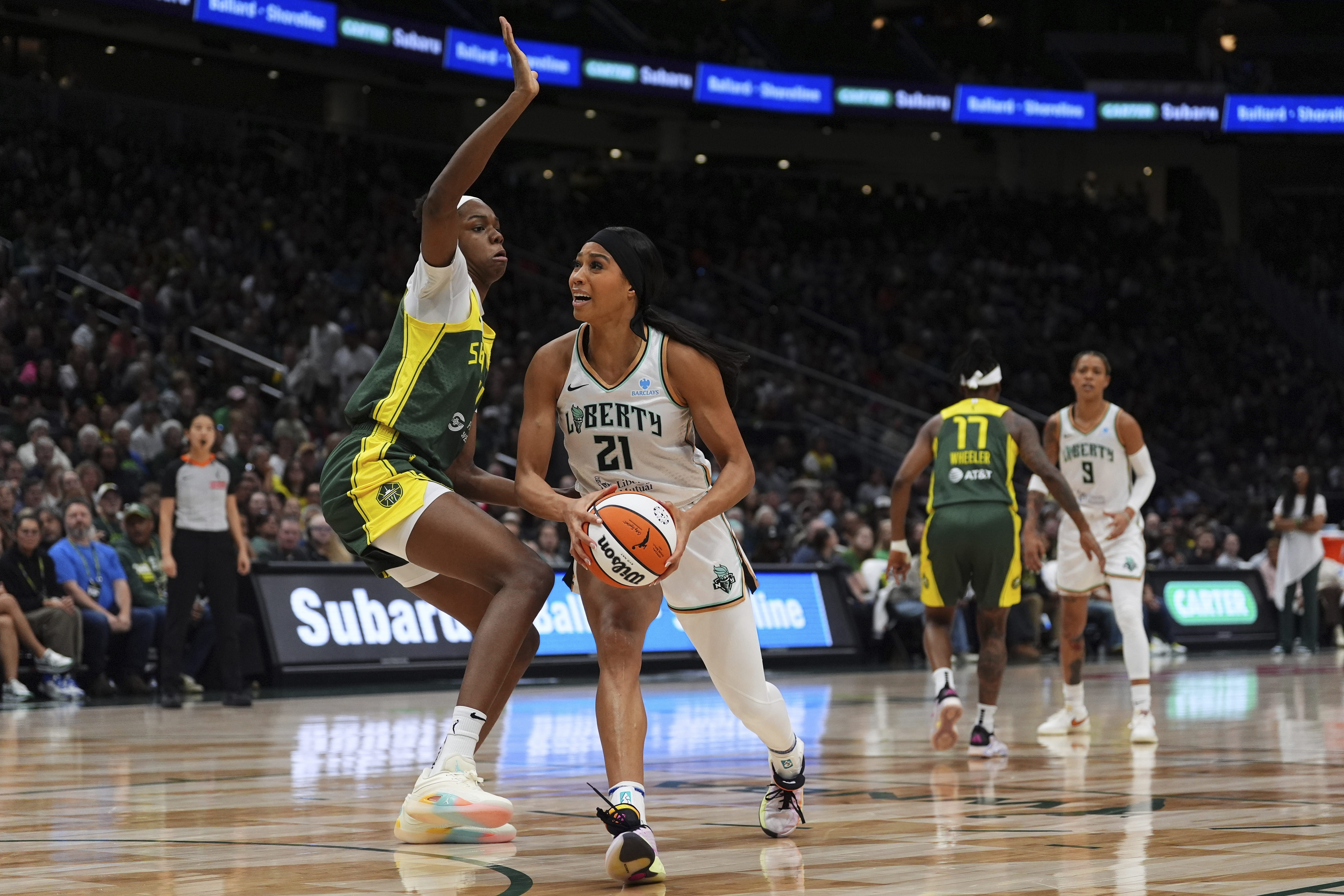 FILE - New York Liberty forward Isabelle Harrison (21) goes to the basket against Seattle Storm center Dominique Malonga, left, during a WNBA basketball game, June 22, 2025, in Seattle. 