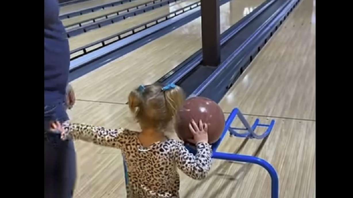 This 3-year-old wants to show everyone she doesn't need anyone's help at the bowling alley.