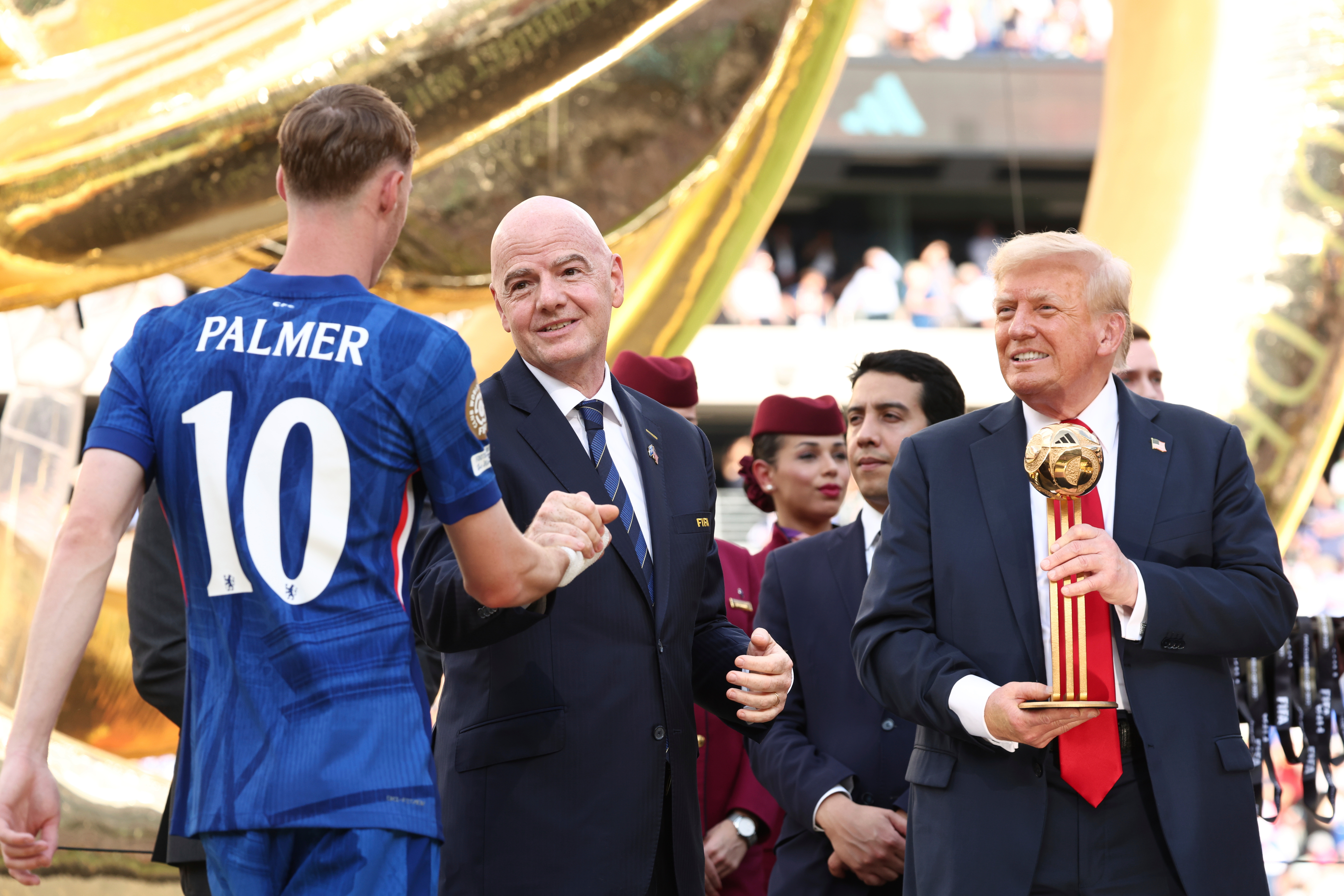 President Donald Trump, from right, and FIFA President Gianni Infantino present Chelsea's Cole Palmer with the golden ball trophy after Chelsea won against Paris St Germain in the Club World Cup final, at MetLife Stadium in East Rutherford, N.J., Sunday, July 13, 2025. 