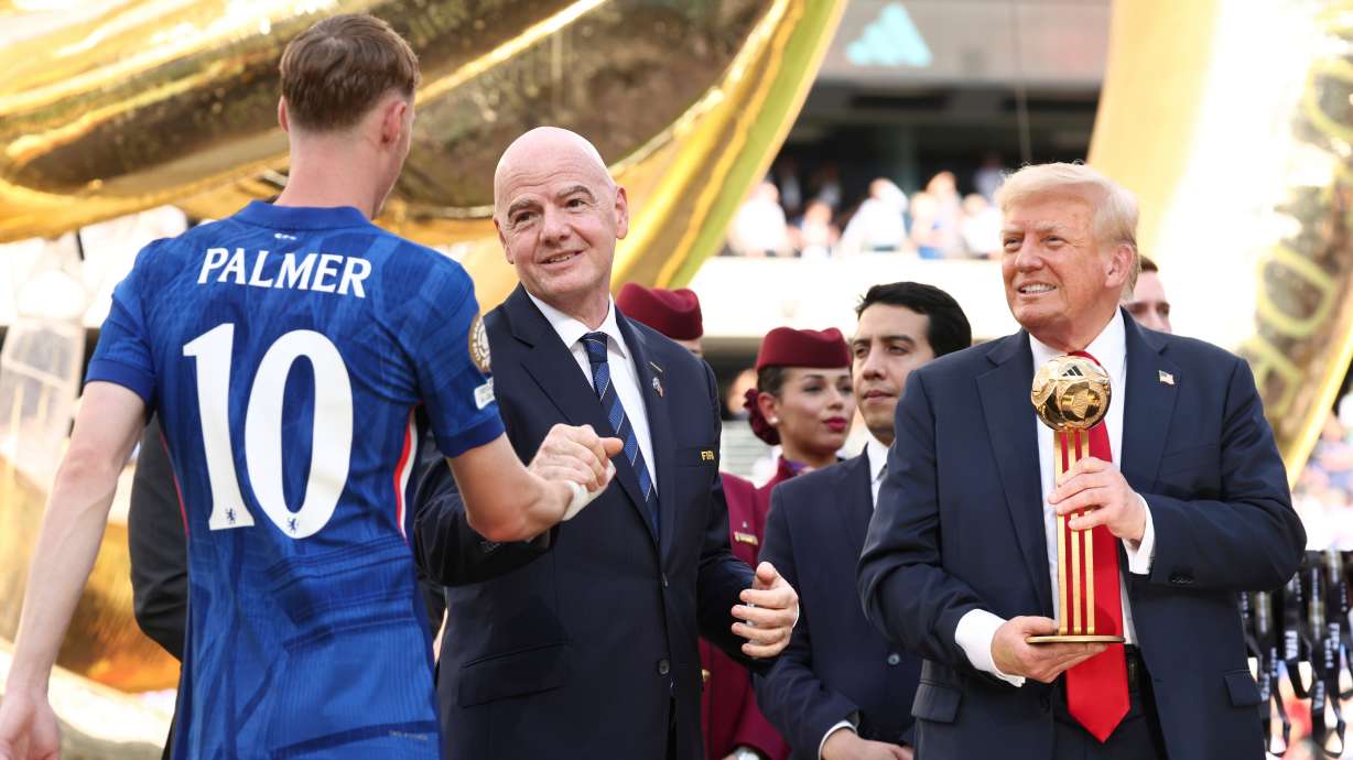 President Donald Trump, from right, and FIFA President Gianni Infantino present Chelsea's Cole Palmer with the golden ball trophy after Chelsea won against Paris St Germain in the Club World Cup final, at MetLife Stadium in East Rutherford, N.J., Sunday, July 13, 2025.