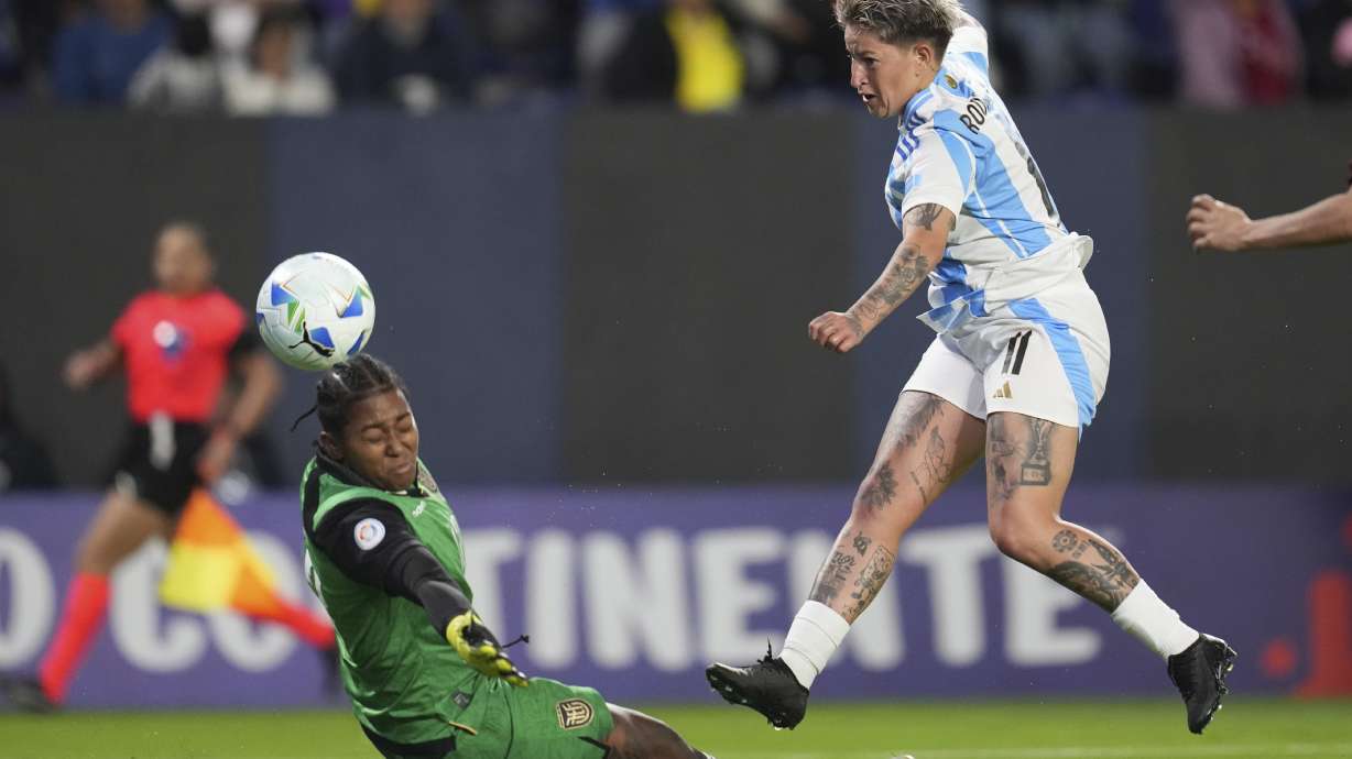 Yamila Rodriguez of Argentina shoots the ball past goalkeeper Andrea Moran of Ecuador during a Women's Copa America soccer match in Quito, Ecuador, Thursday, July 24, 2025.