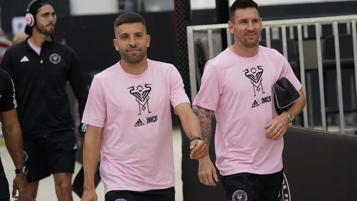 FILE - Inter Miami defender Jordi Alba, left, and forward Lionel Messi chat as they arrive before the start of an MLS soccer match against Toronto FC, Wednesday, Sept. 20, 2023, in Fort Lauderdale, Fla.