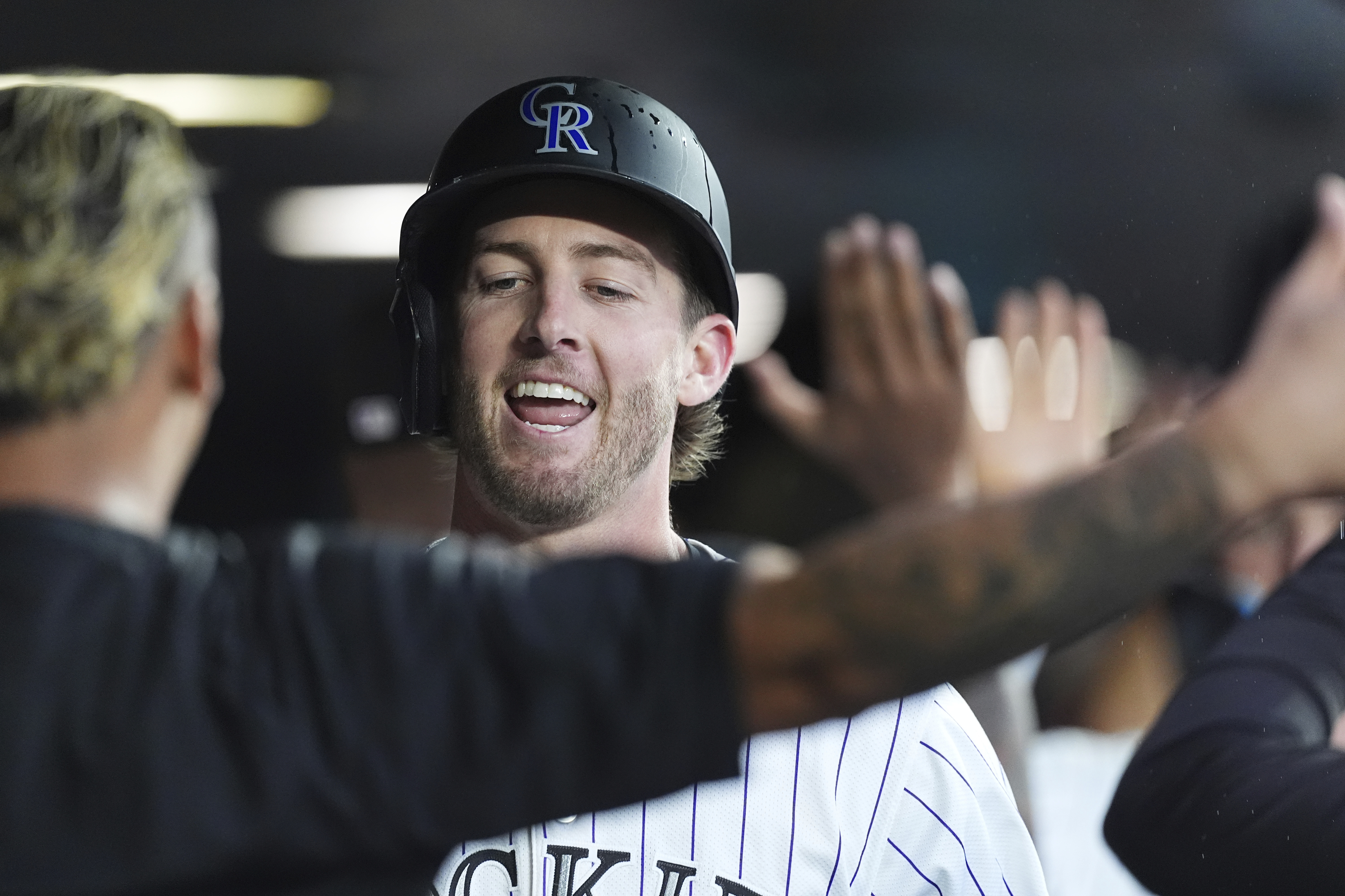 Colorado Rockies' Orlando Arcia, left, congratulates Ryan McMahon as he returns to the dugout after hitting a two-run home run off St. Louis Cardinals starting pitcher Erick Fedde in the third inning of a baseball game Tuesday, July 22, 2025, in Denver. 