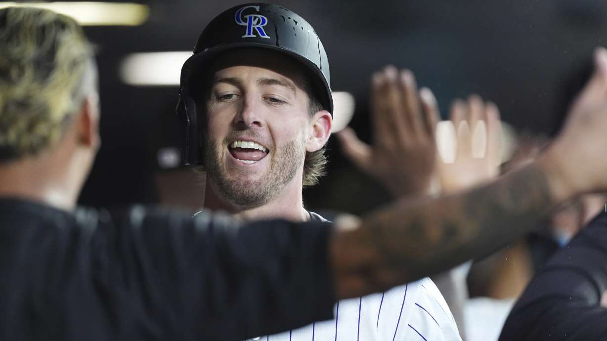 Colorado Rockies' Orlando Arcia, left, congratulates Ryan McMahon as he returns to the dugout after hitting a two-run home run off St. Louis Cardinals starting pitcher Erick Fedde in the third inning of a baseball game Tuesday, July 22, 2025, in Denver.