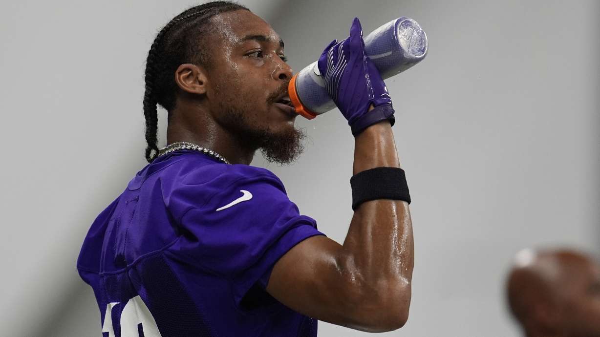 Minnesota Vikings wide receiver Justin Jefferson (18) hydrates during the team's NFL football training camp Wednesday, July 23, 2025, in Eagan, Minn.