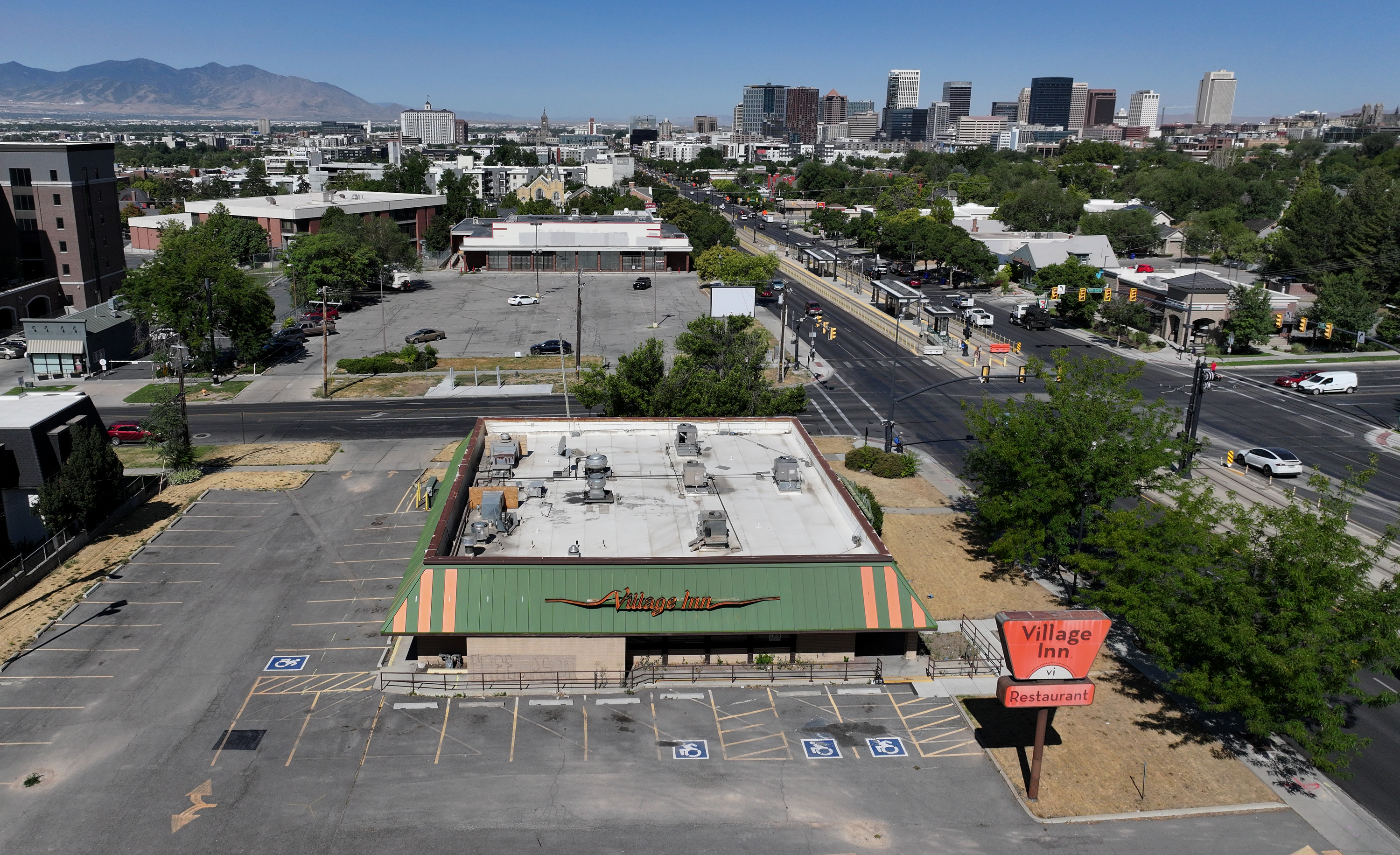 The shuttered Village Inn and OfficeMax locations in Salt Lake City are pictured on July 25. The sites are now set to be replaced by a new townhome complex and student housing over the next few years.