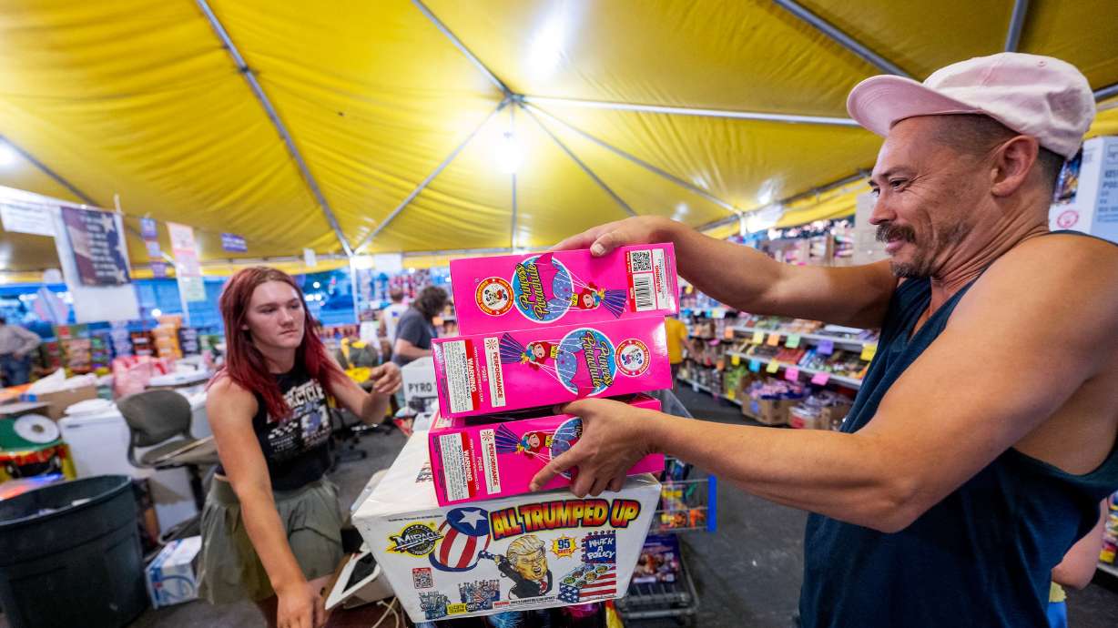 Lily Shadle helps Josh Sato pay at Mad Matt’s Fireworks in Sandy at 9000 South and State Street on July 2. A recent Deseret News poll found Utahns are split on firework restrictions when considering environmental impact.