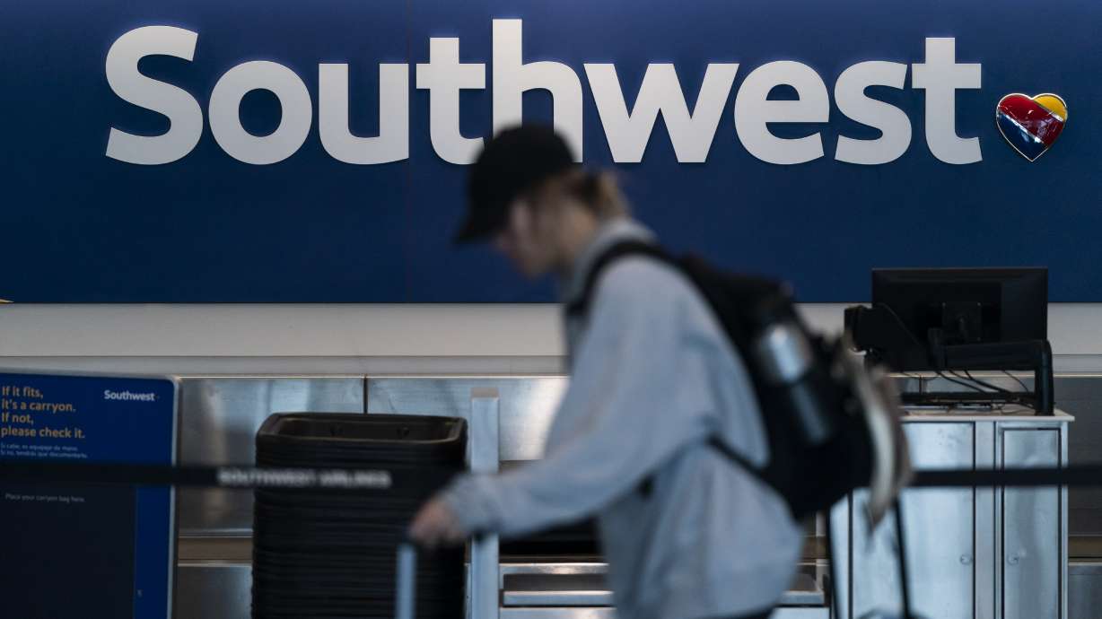 A traveler walks through the Southwest Airlines ticketing counter area at the Los Angeles International Airport in Los Angeles, April 18, 2023.