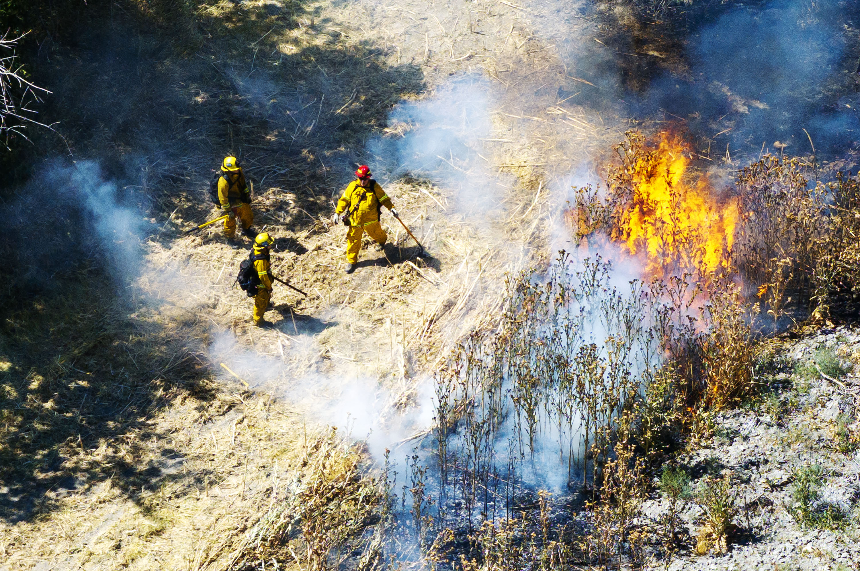 Firefighters work to douse a fire burning near 4600 South and 1300 East in Millcreek on Friday. The fire destroyed two apartment buildings, displacing residents of 24 units.