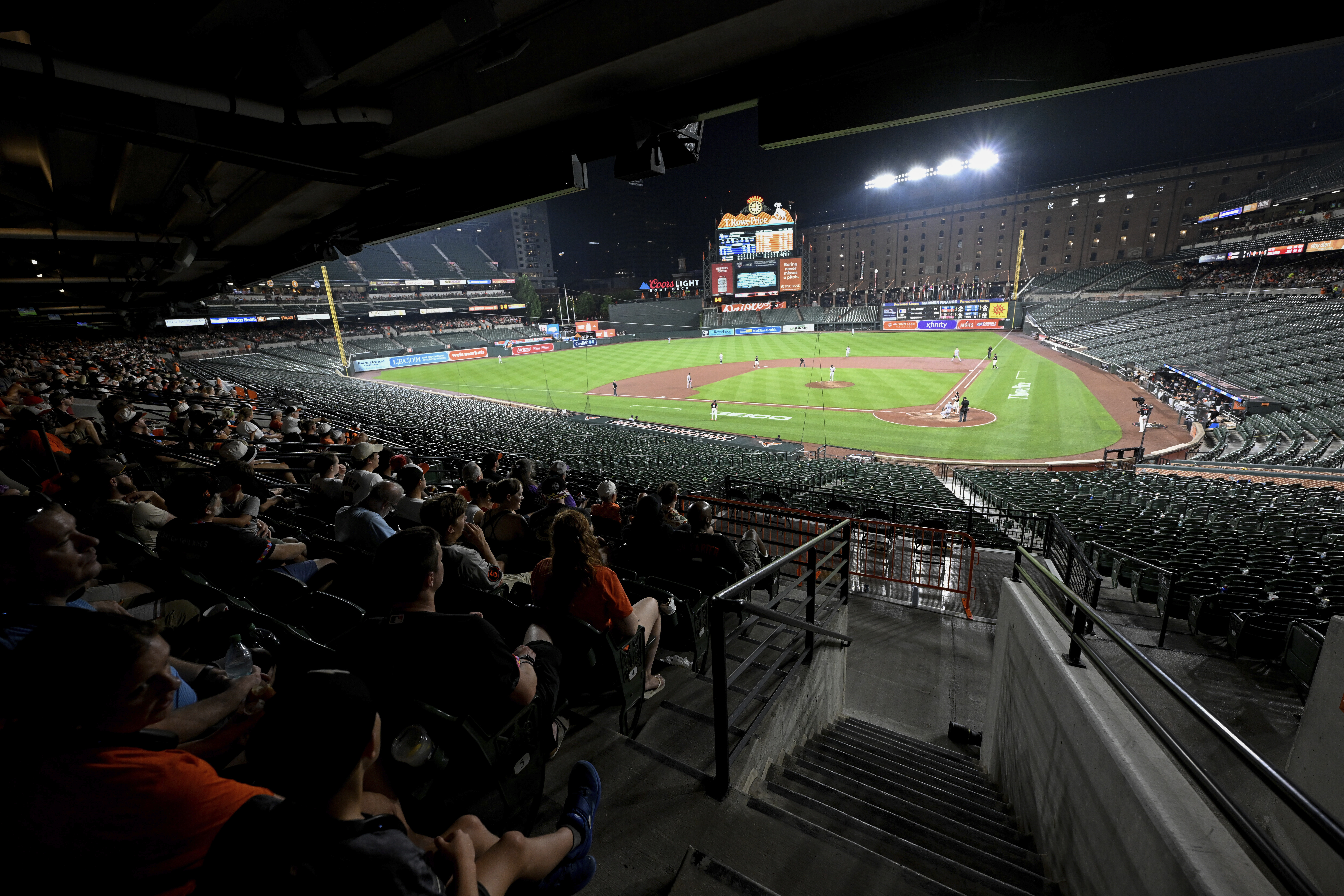 Fans have vacated the lower bowl during a thunderstorm in the seventh inning of a baseball game between the Baltimore Orioles and the Colorado Rockies in Baltimore, Friday, July 25, 2025. 