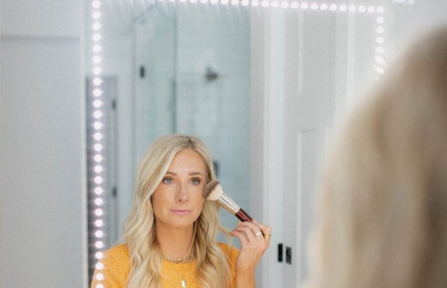 Lauren Hale applies makeup in the mirror. The 44-year-old mother of three from Pocatello has found success a beauty influencer and best-selling author.