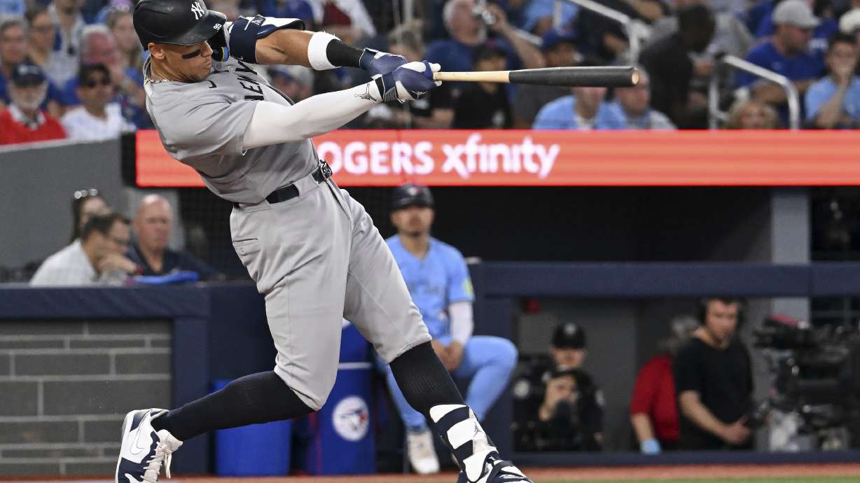 New York Yankees' Aaron Judge (99) hits a two-run home run against the Toronto Blue Jays in the sixth inning of a baseball game in Toronto on Wednesday, July 23, 2025.
