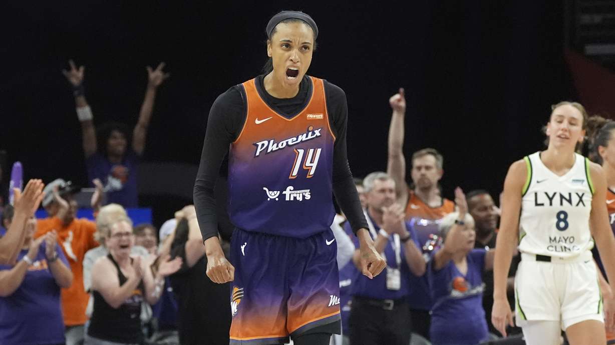 Phoenix Mercury forward DeWanna Bonner celebrates a Mercury score as Minnesota Lynx forward Alanna Smith (8) pauses on the court during the second half of a WNBA basketball game Wednesday, July 9, 2025, in Phoenix.