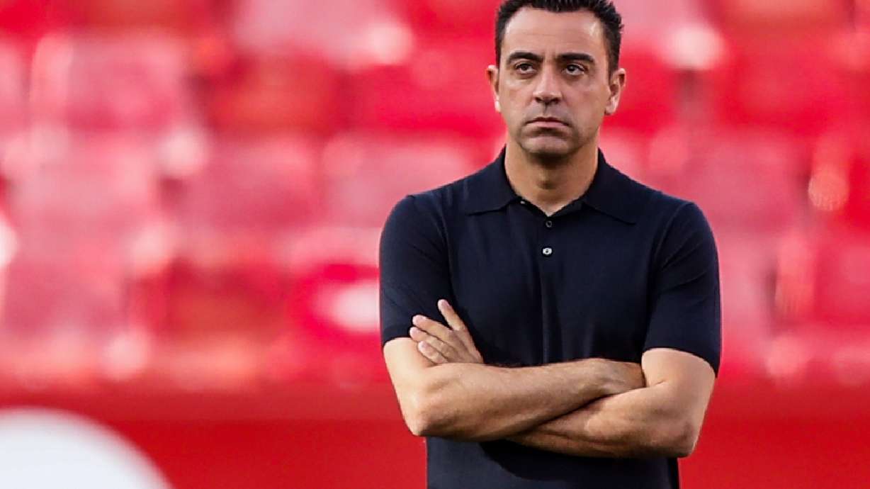 FILE - Barcelona's head coach Xavi Hernandez watches before the Spanish La Liga soccer match between Sevilla and FC Barcelona at the Ramon Sanchez Pizjuan stadium in Seville, Spain, Sunday, May 26, 2024.