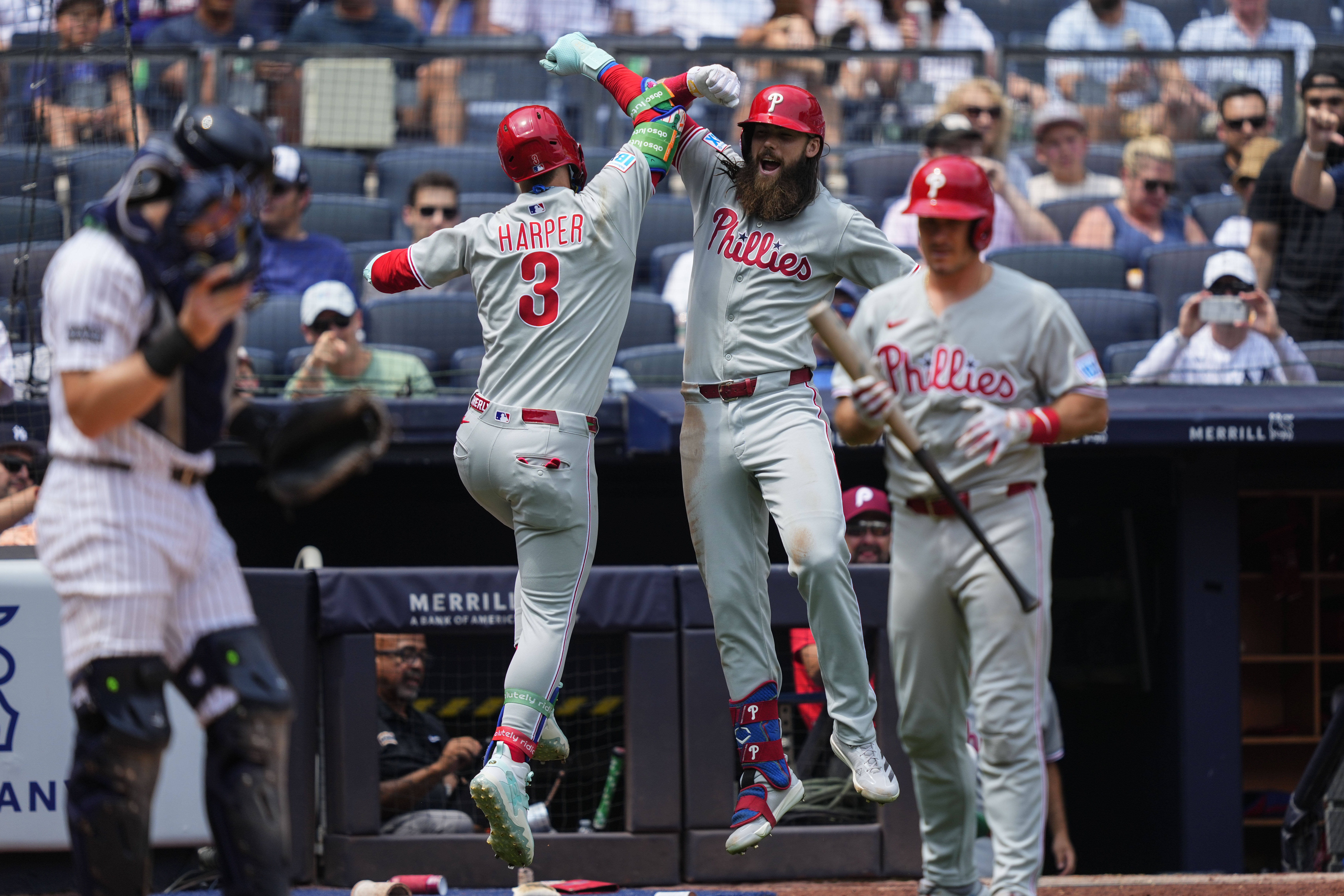 Philadelphia Phillies' Bryce Harper (3) and' Brandon Marsh (16) celebrate after Harper hit a home run during the third inning of a baseball game against the New York Yankees, Saturday, July 26, 2025, in New York. 