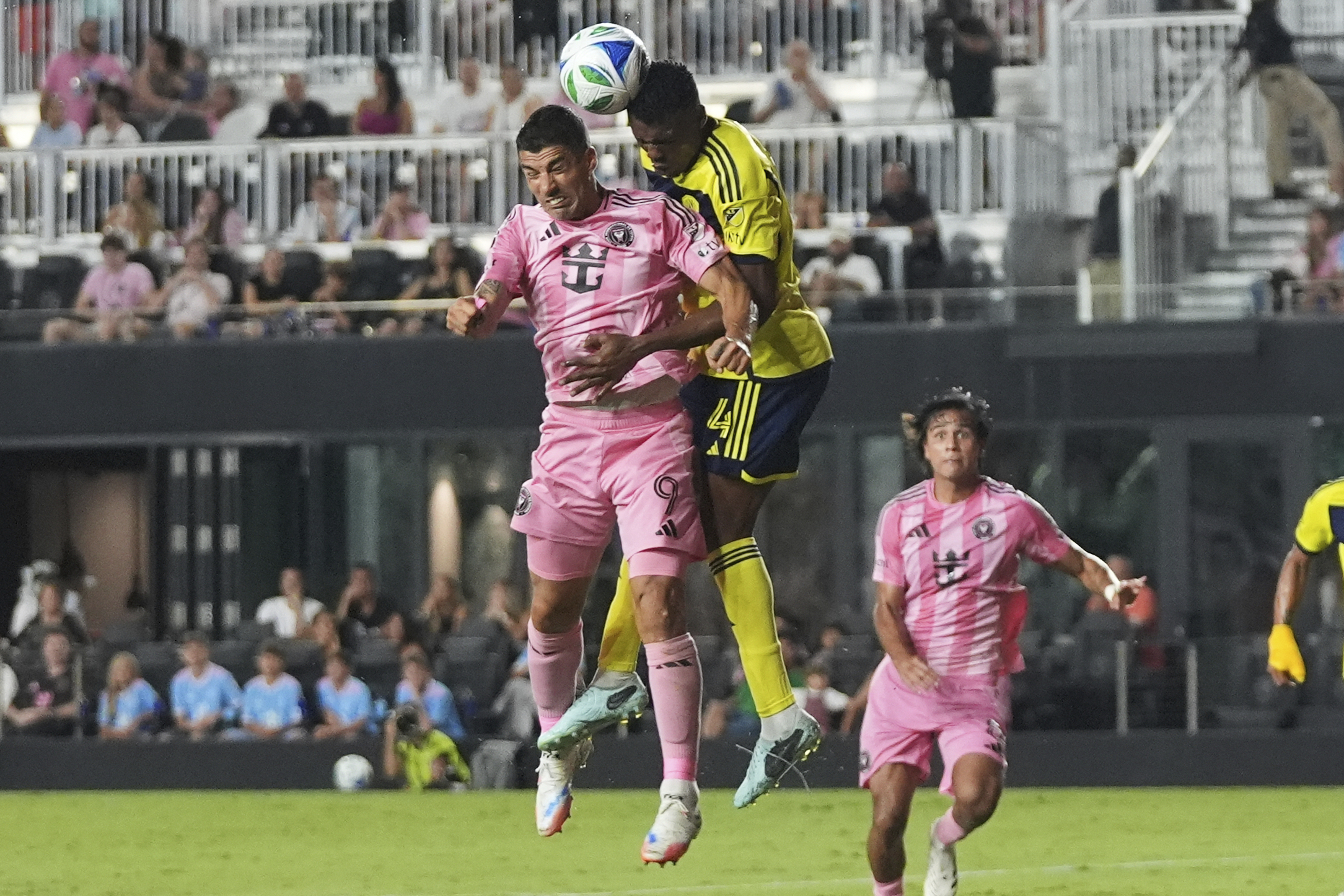 Inter Miami forward Luis Suarez (9) heads the ball against Nashville SC defender Jeisson Palacios (4) during the second half of an MLS soccer match, Saturday, July 12, 2025, in Fort Lauderdale, Fla.