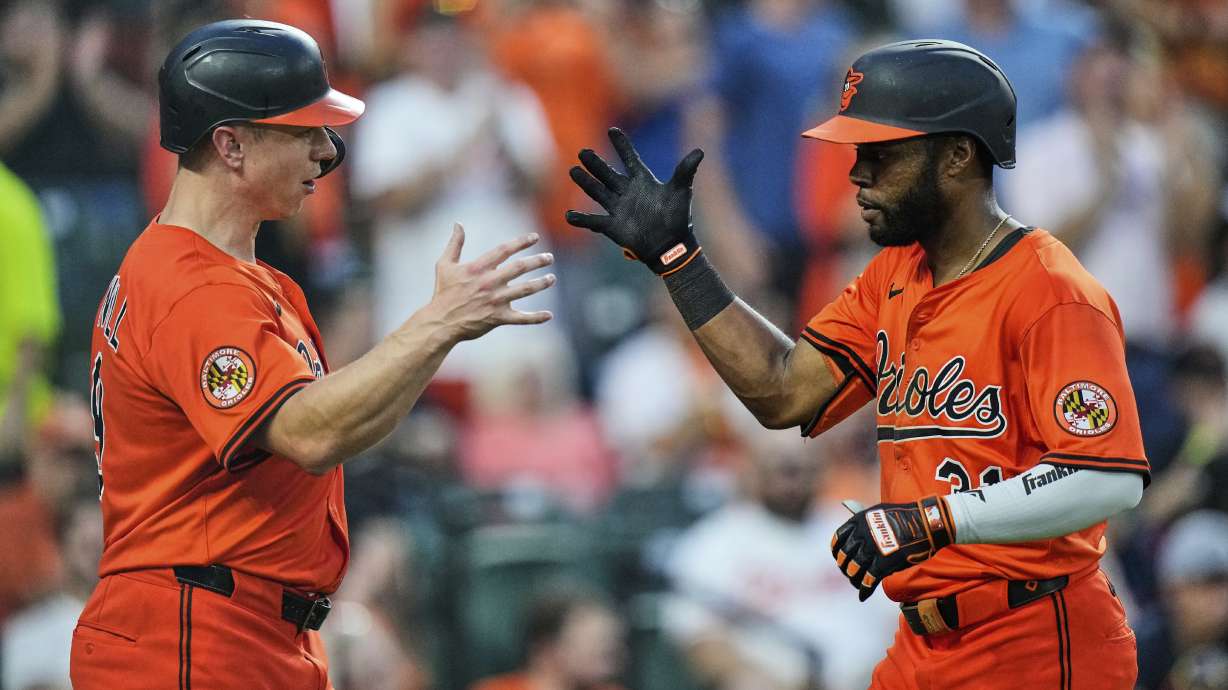 Baltimore Orioles' Cedric Mullins, right, celebrates with Tyler O'Neill, left, after hitting a three-run home run during the fourth inning of a baseball game against the Colorado Rockies, Saturday, July 26, 2025, in Baltimore.