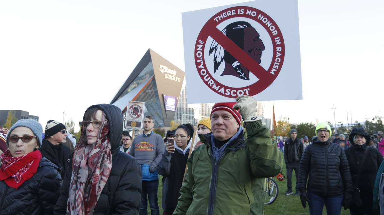 FILE - Native American leaders protest against the Redskins team name and logo outside U.S. Bank Stadium before an NFL football game between the Minnesota Vikings and the Washington Redskins in Minneapolis on Oct. 24, 2019.