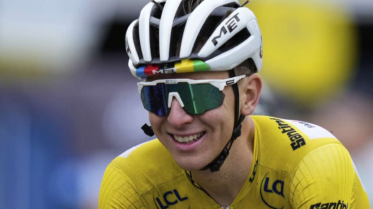 A smiling Slovenia's Tadej Pogacar, wearing the overall leader's yellow jersey, crosses the finish line of the twentieth stage of the Tour de France cycling race over 184.2 kilometers (114.5 miles) with start in Nantua and finish in Pontarlier, France, Saturday, July 26, 2025.