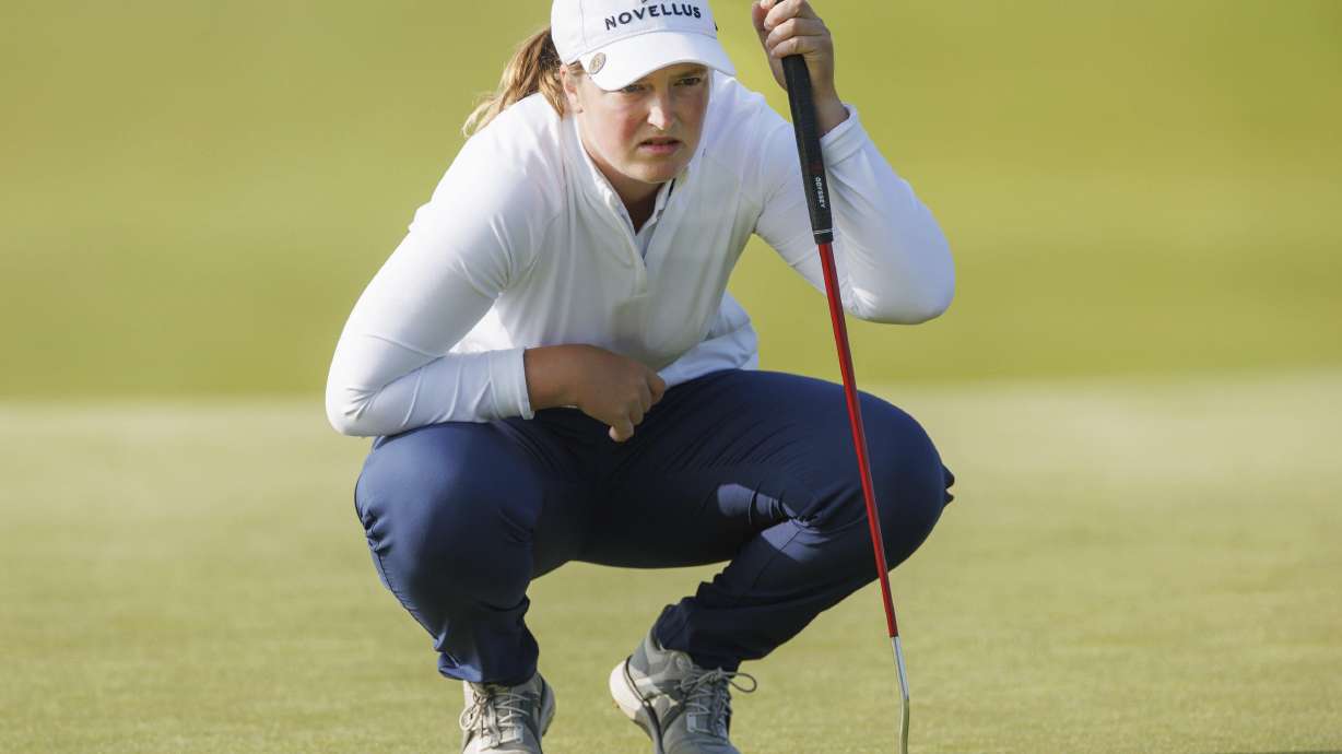Lottie Woad, of England, looks over her line during the first round of the women's Scottish Open golf tournament, Thursday, July 24, 2025, at Dundonald Links in Irvine, Scotland.