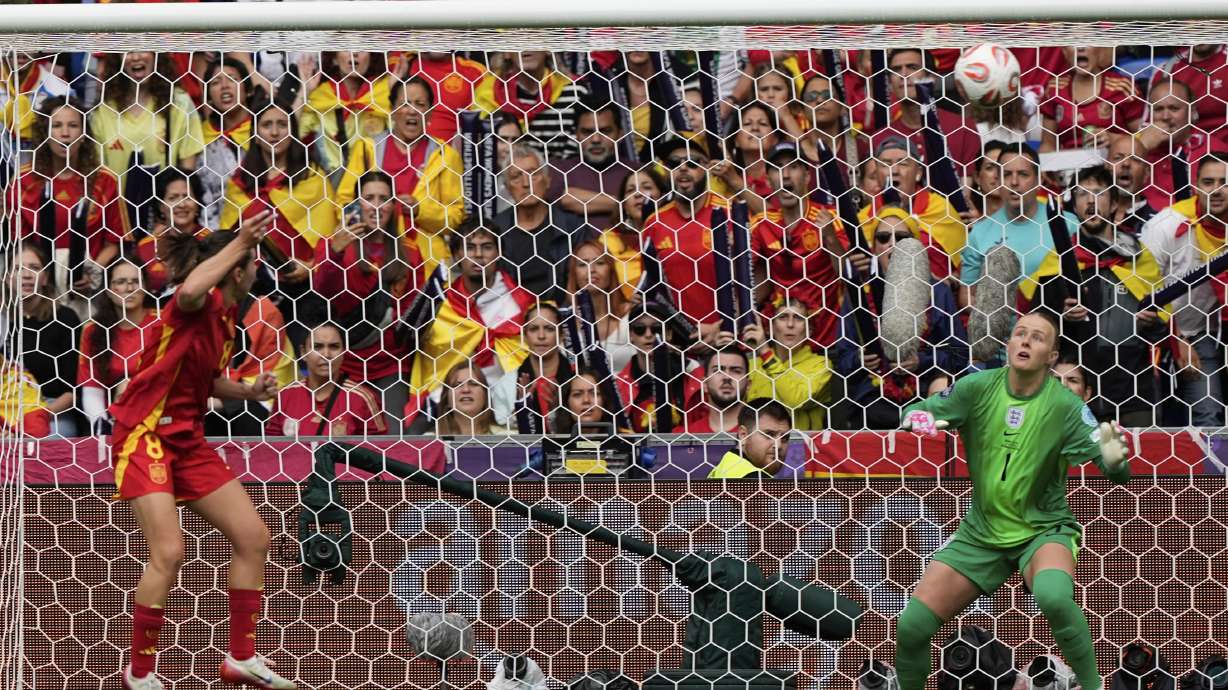 Spain's Mariona Caldentey, left, scores her sides first goal past England goalkeeper Hannah Hampton during the Women's Euro 2025 final soccer match between England and Spain at St. Jakob-Park in Basel, Switzerland, Sunday, July 27, 2025.