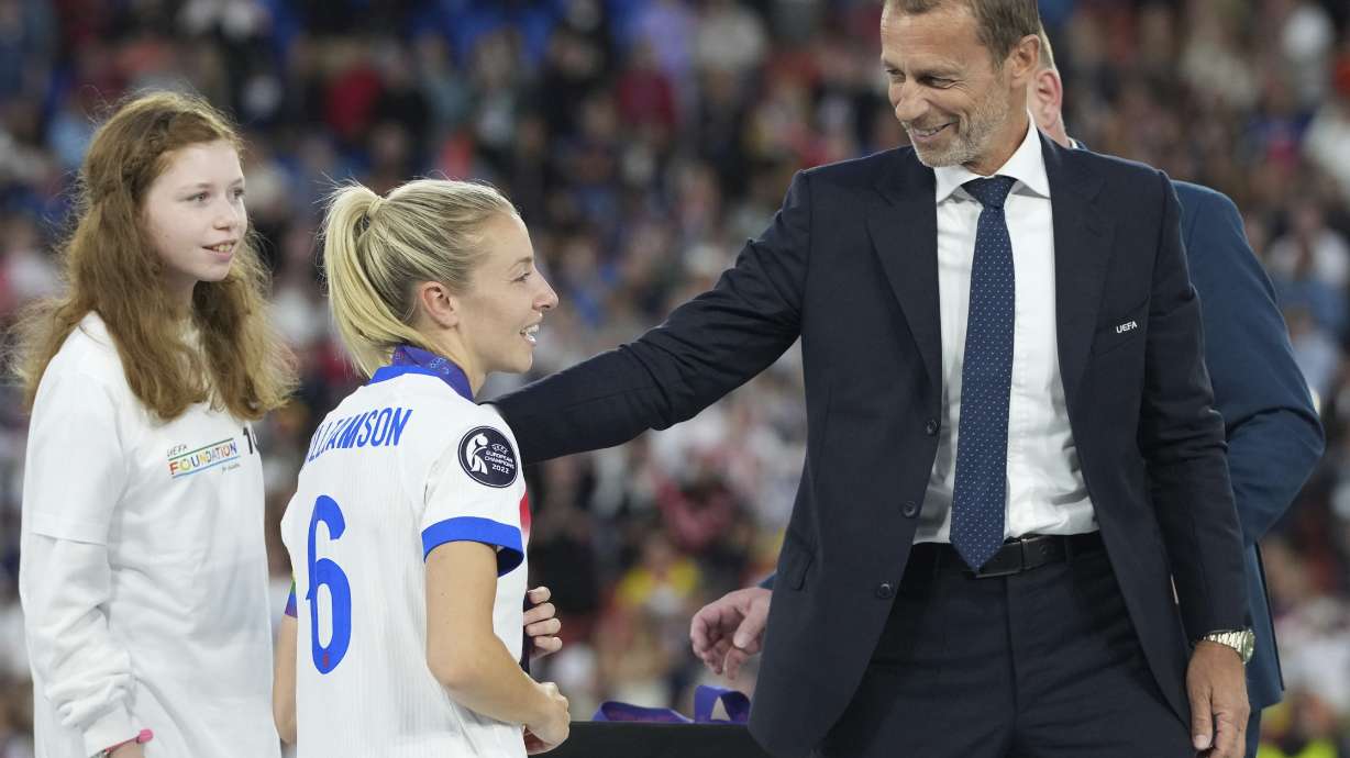 UEFA president Aleksander Ceferin congratulates to England's Leah Williamson after the Women's Euro 2025 final soccer match between England and Spain at St. Jakob-Park in Basel, Switzerland, Sunday, July 27, 2025.