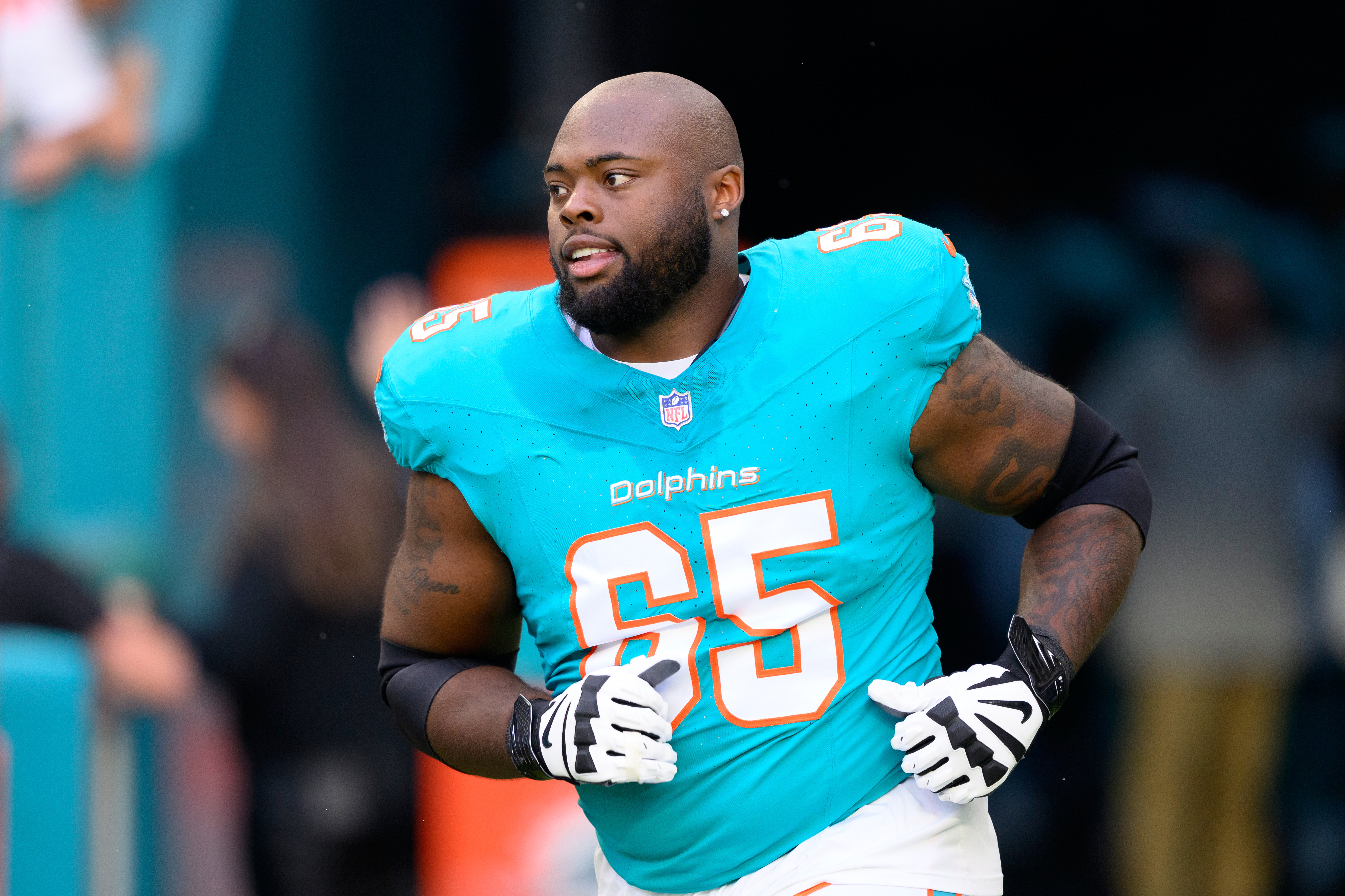 FILE - Miami Dolphins offensive lineman Robert Jones (65) runs onto the field during player introductions before an NFL football game against the San Francisco 49ers, Sunday, Dec. 22, 2024, in Miami Gardens, Fla.