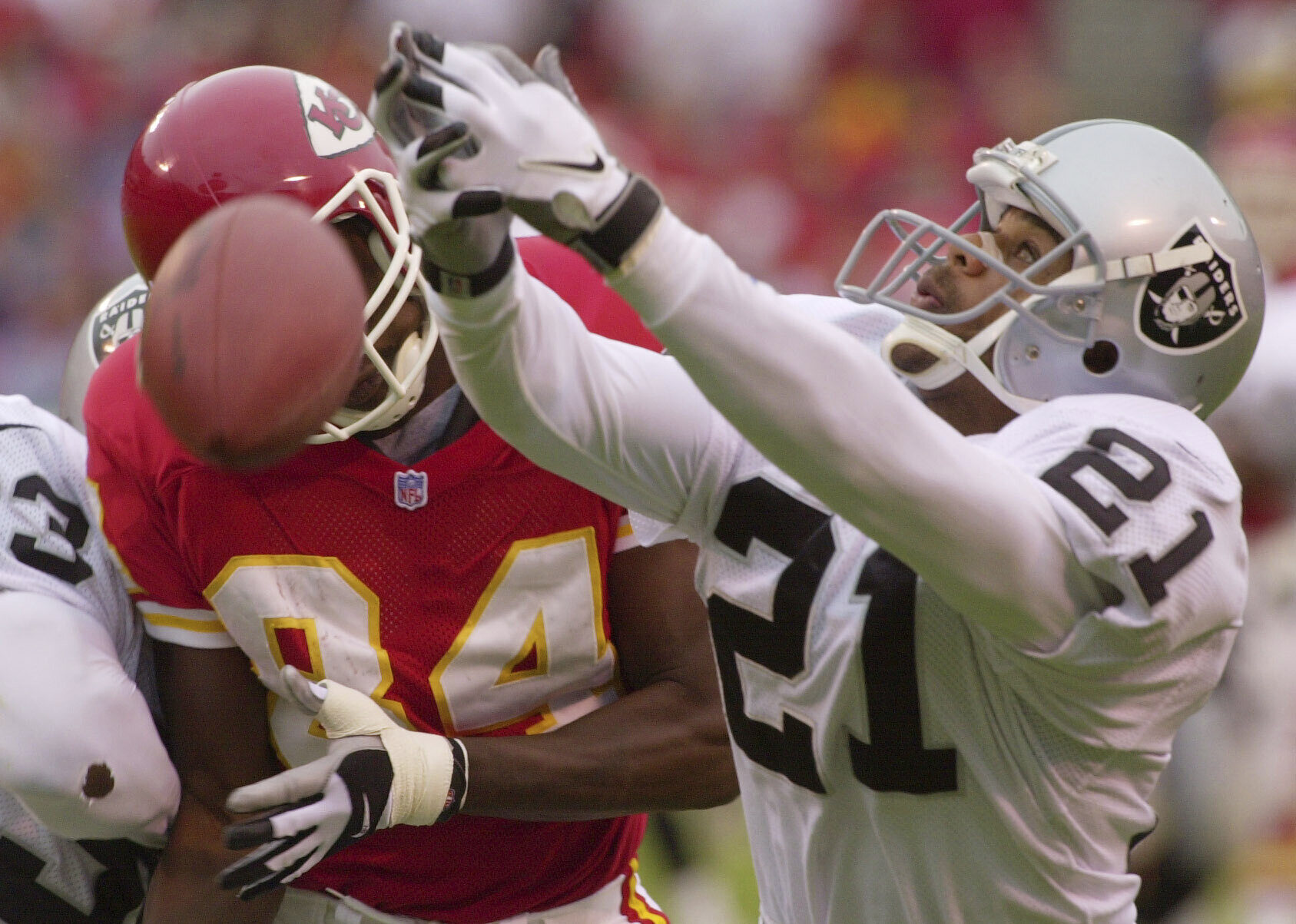 FILE - Oakland Raiders cornerback Eric Allen (21) almost intercepts a pass intended for Kansas City Chiefs' Sylvester Morris (84) in the second quarter in this Oct. 15, 2000 file photo, in Kansas City, Mo. 