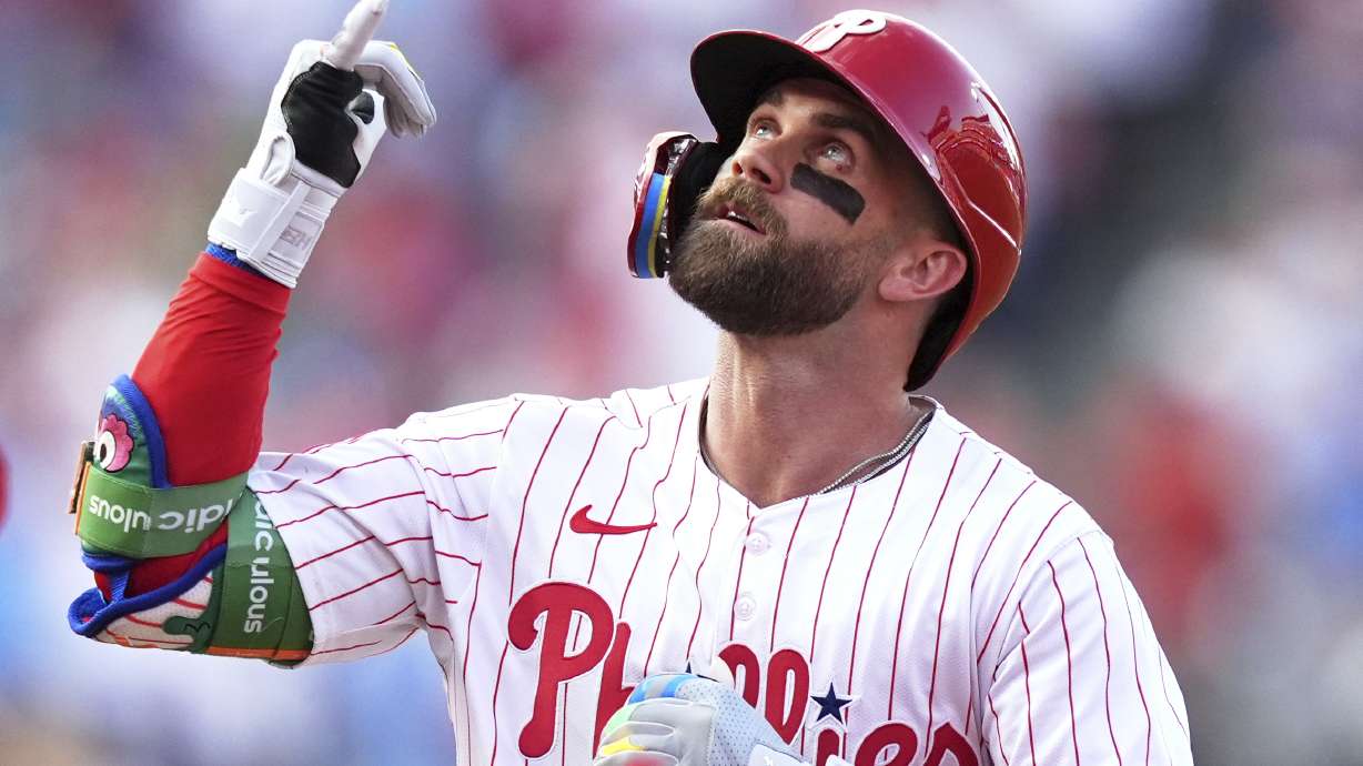 Philadelphia Phillies' Bryce Harper reacts after hitting a home run against Boston Red Sox pitcher Lucas Giolito during the first inning of a baseball game Wednesday, July 23, 2025, in Philadelphia.