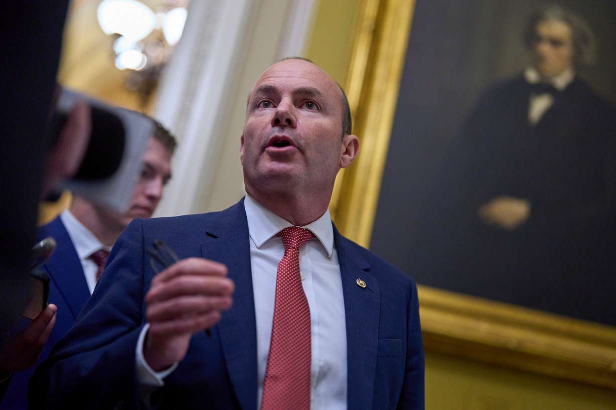 Sen. Mike Lee, R-Utah, speaks to a reporter as senators arrive for votes and policy meetings at the Capitol in Washington, June 17.