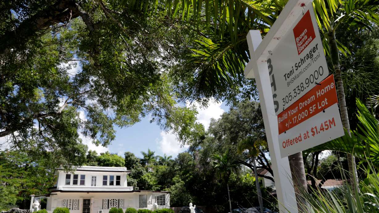 A for sale sign is posted in front of a home in Miami on July 22, 2019.