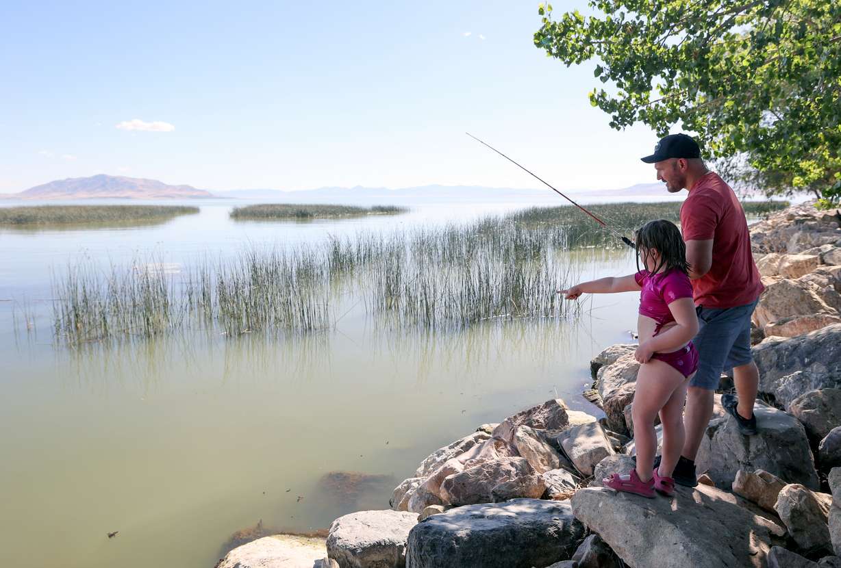 Stuart Webb fishes with his daughter, Sailor Webb, at Utah Lake State Park in Provo on Monday.