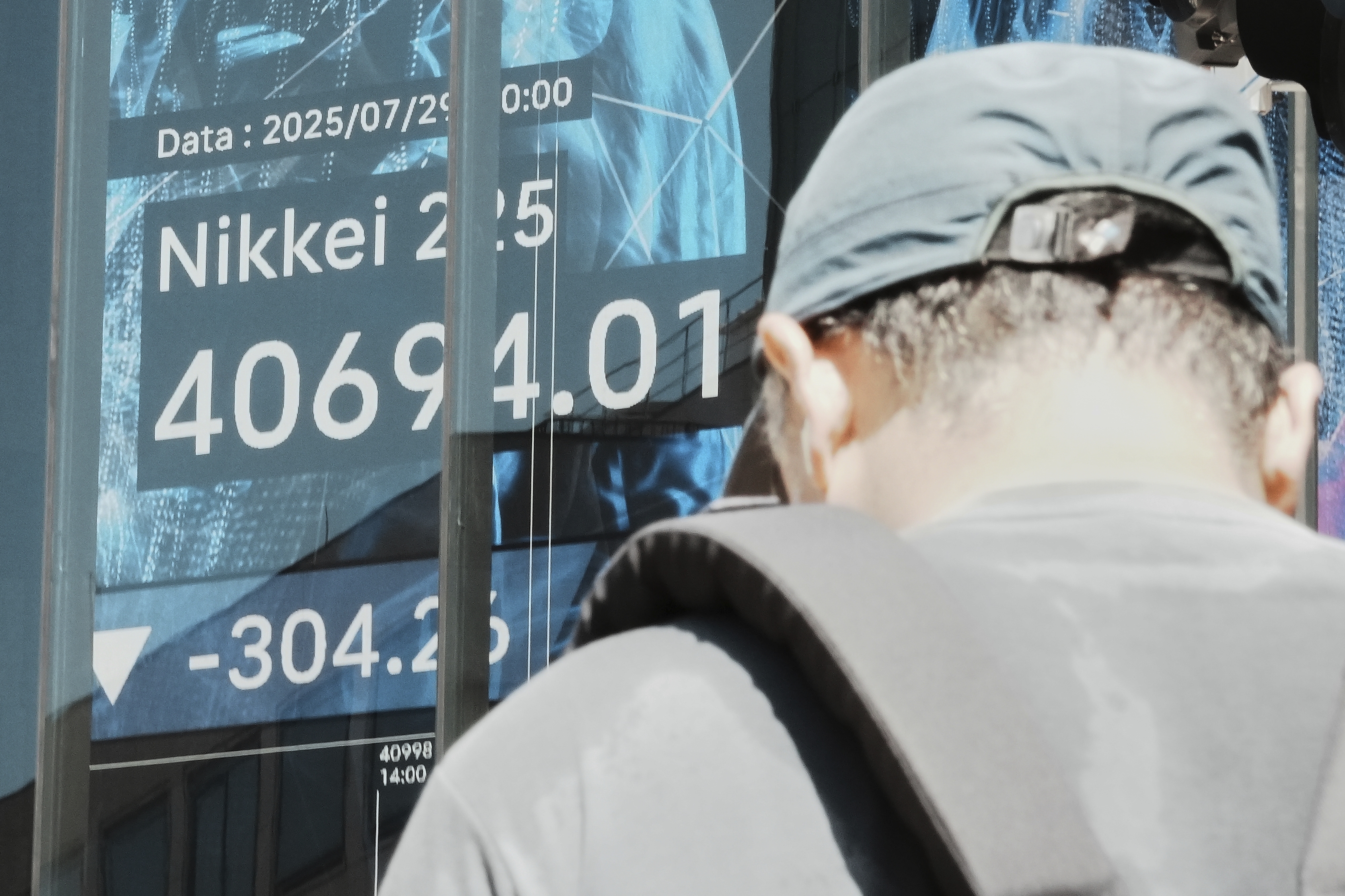 Wall Street edges back from its records as a busy week picks up momentum