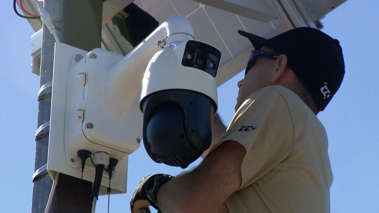 Aaron Langston, co-owner of CollisionCam, installs a camera at an intersection.