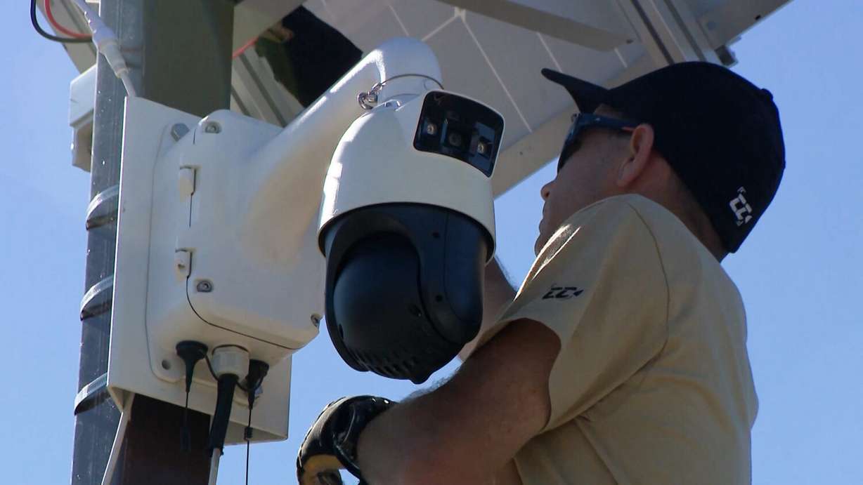 Aaron Langston, co-owner of CollisionCam, installs a camera at an intersection.