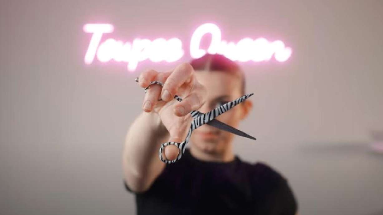 The "Toupee Queen" Emily Cheney, who lives in Ogden and San Diego, California, poses with shears in a video related to her toupee business.