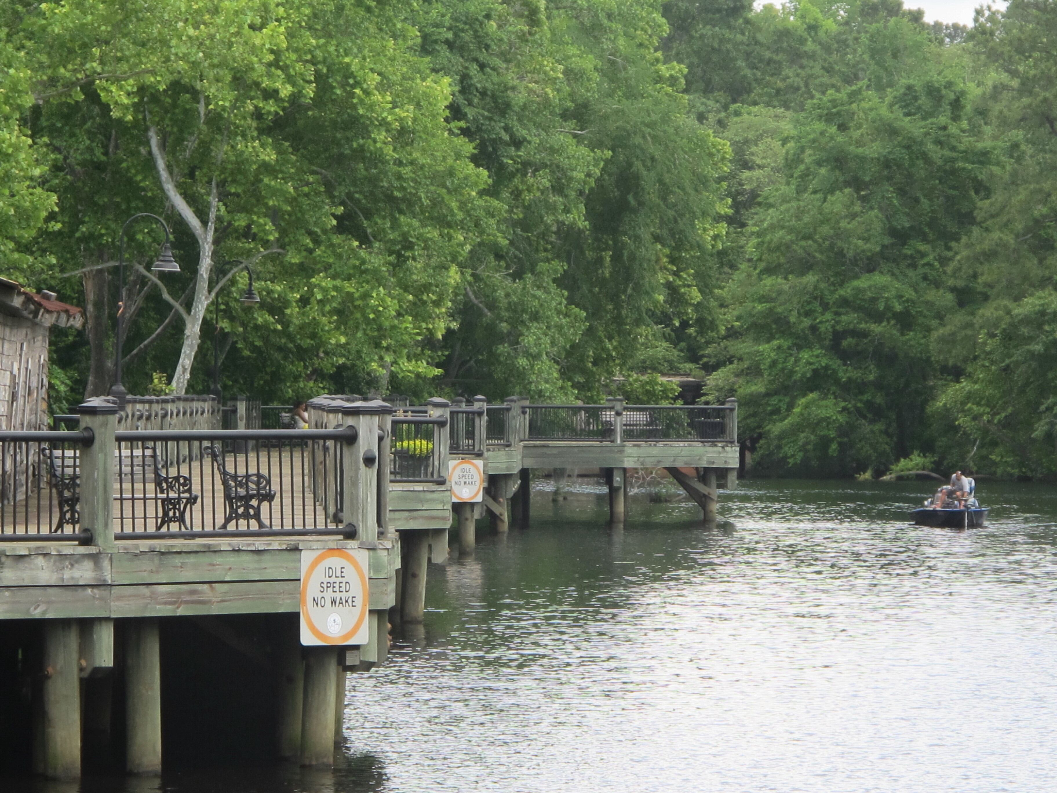 On May 22, 2013, a fisherman uses a small boat near the River Walk in Conway, S.C. South Carolina tourism officials say a campaign to attract visitors to undiscovered areas of the state is paying off. North Carolina has a similar effort to attract tourists to less-visited areas.