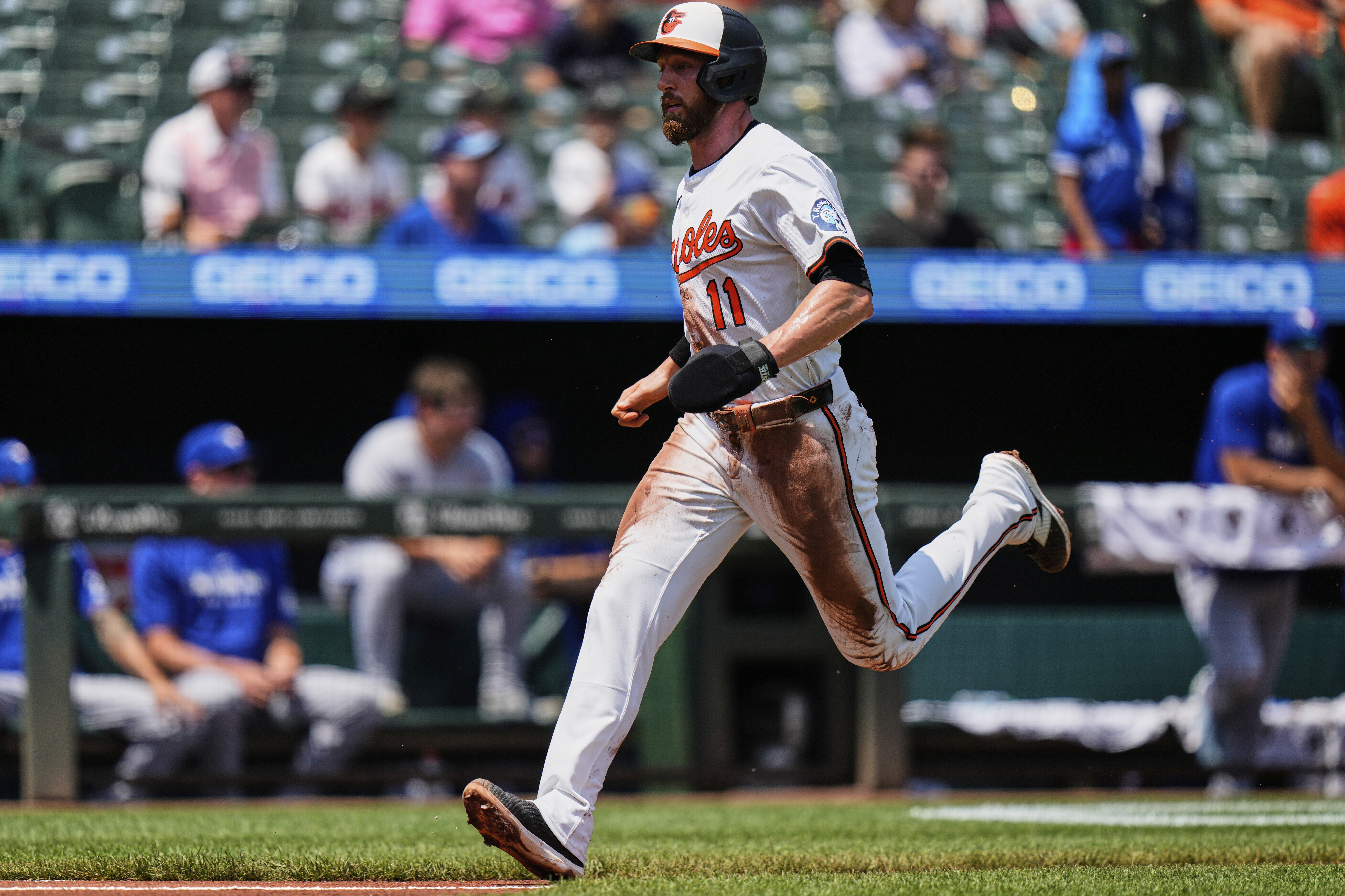 Baltimore Orioles' Jordan Westburg (11) advances toward home plate to score on a sacrifice fly hit by Tyler O'Neill during the first inning in the first baseball game of a doubleheader against the Toronto Blue Jays, Tuesday, July 29, 2025, in Baltimore. 